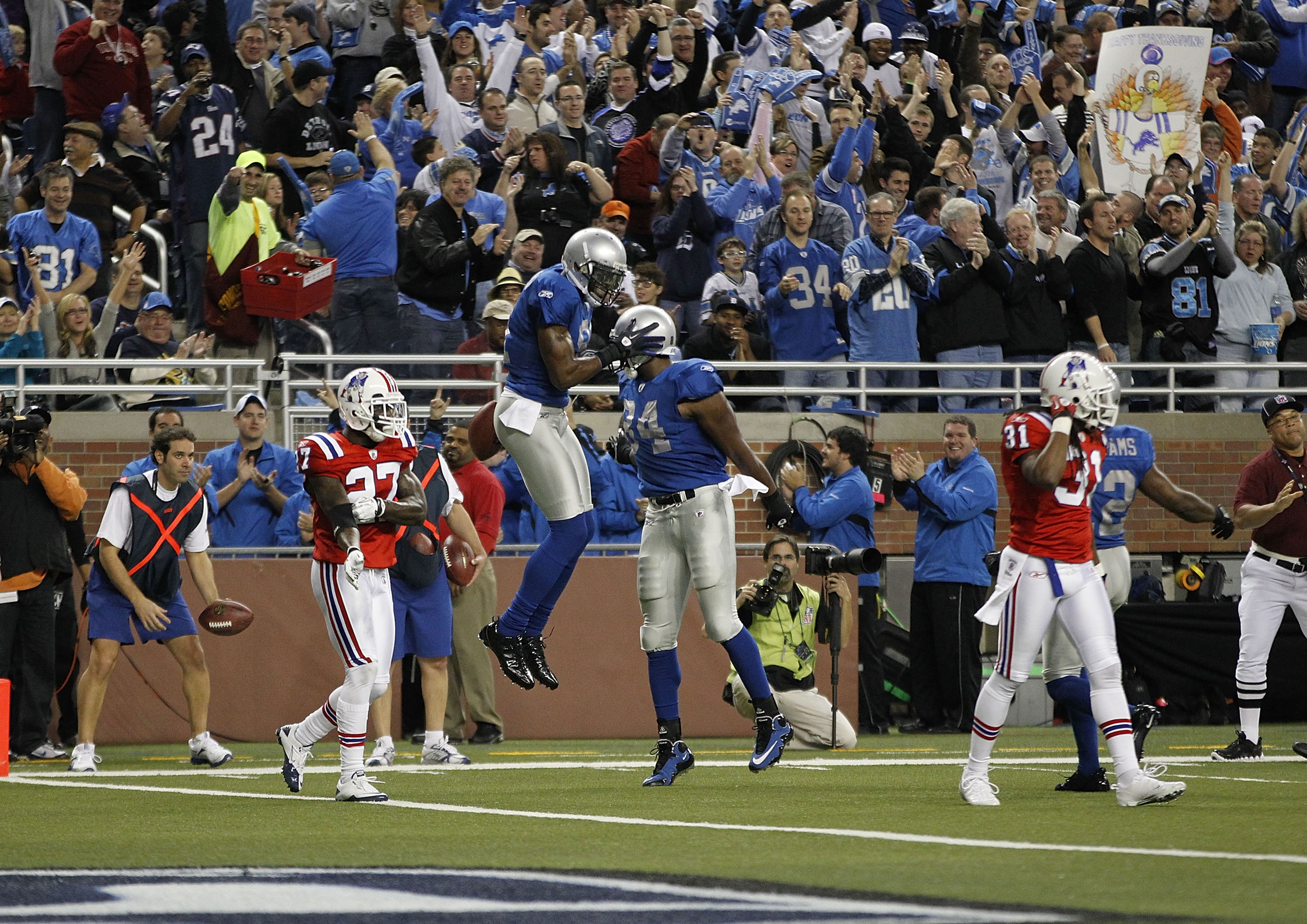 DETROIT - NOVEMBER 25:  Calvin Johnson #81 of the Detroit Lions celebrates a first quarter touchdown with teammate Brandon Pettigrew #84 to give the Lions a 7-3 lead over the New England Patriots at Ford Field on November 25, 2010 in Detroit, Michigan.  (