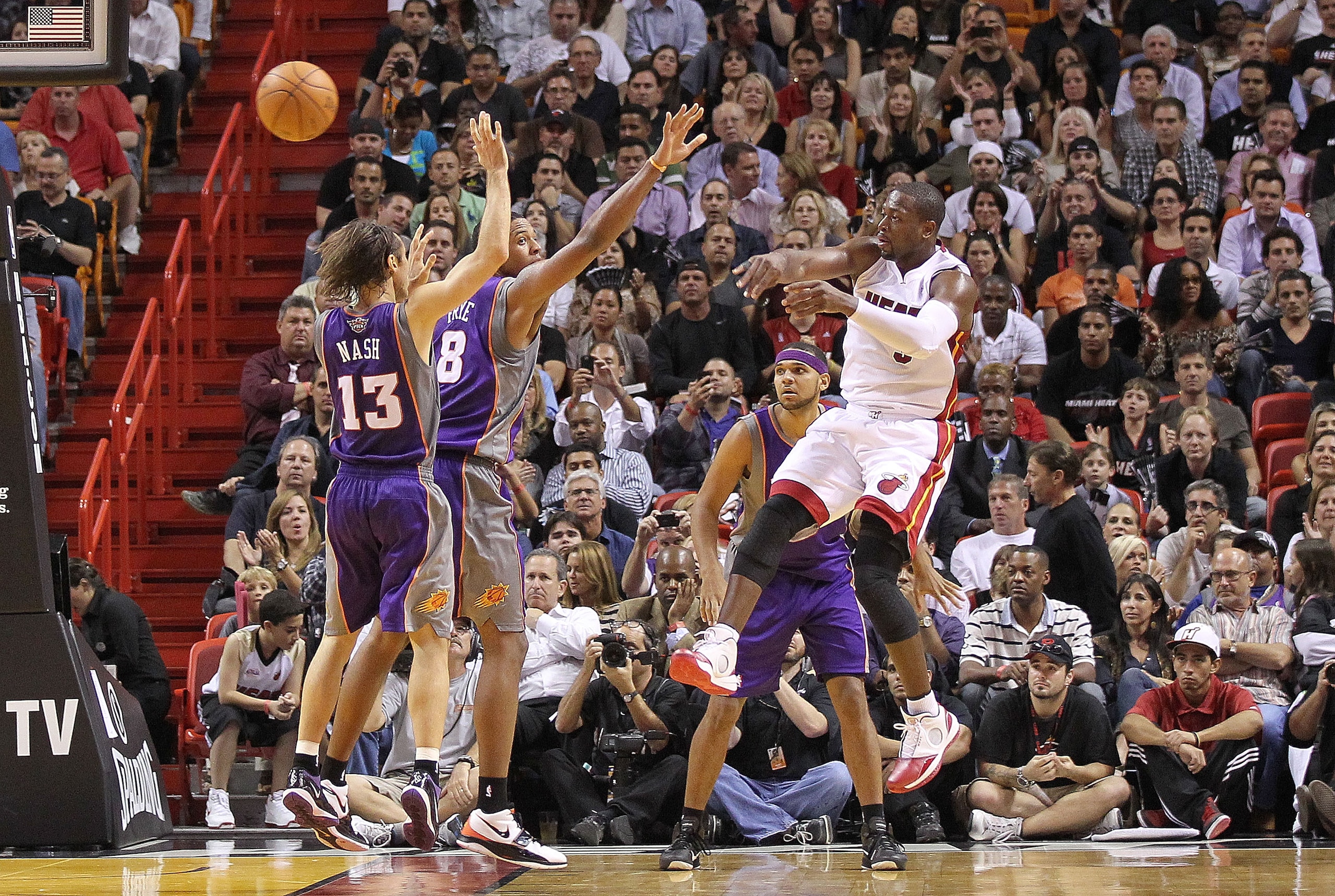 MIAMI - NOVEMBER 17:  Dwyane Wade #3 of the Miami Heat passes the ball over Steve Nash #13 during a game against the Phoenix Suns at American Airlines Arena on November 17, 2010 in Miami, Florida. NOTE TO USER: User expressly acknowledges and agrees that,