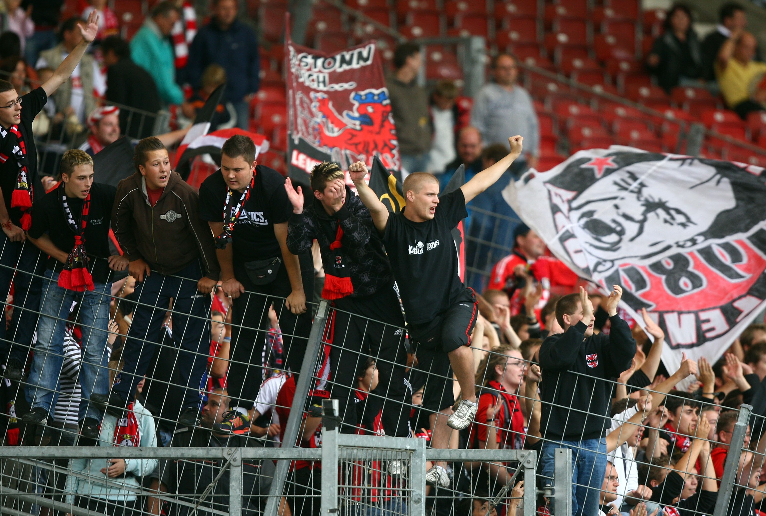 STUTTGART, GERMANY - AUGUST 23:  Supporters of Leverkusen celebrate after the Bundesliga match between VfB Stuttgart and Bayer Leverkusen at the Mercedes-Benz Arena on August 23, 2008 in Stuttgart, Germany.  (Photo by Johannes Simon/Bongarts/Getty Images)