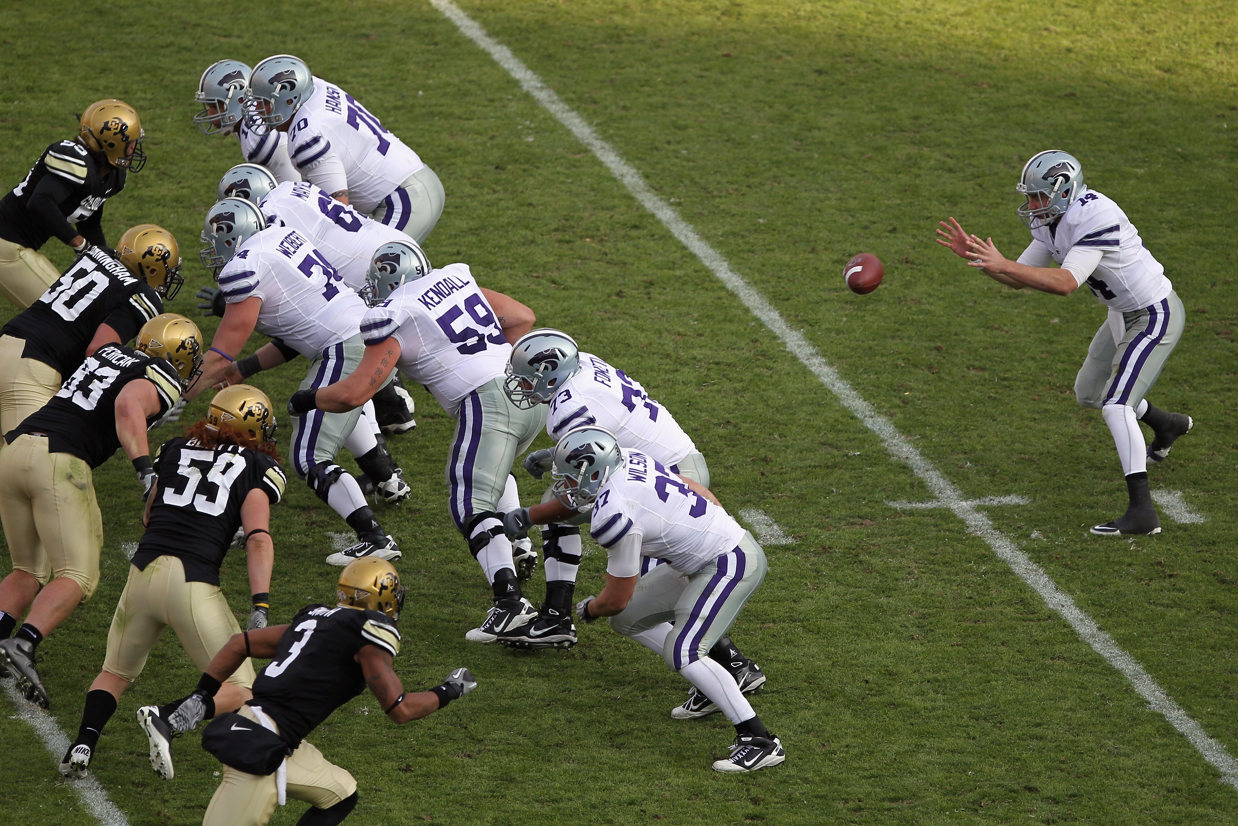 BOULDER, CO - NOVEMBER 20:  Quarterback Carson Coffman #14 of the Kansas State Wildcats takes the snap against the Colorado Buffaloes defense at Folsom Field on November 20, 2010 in Boulder, Colorado. Colorado defeated Kansas State 44-36.  (Photo by Doug