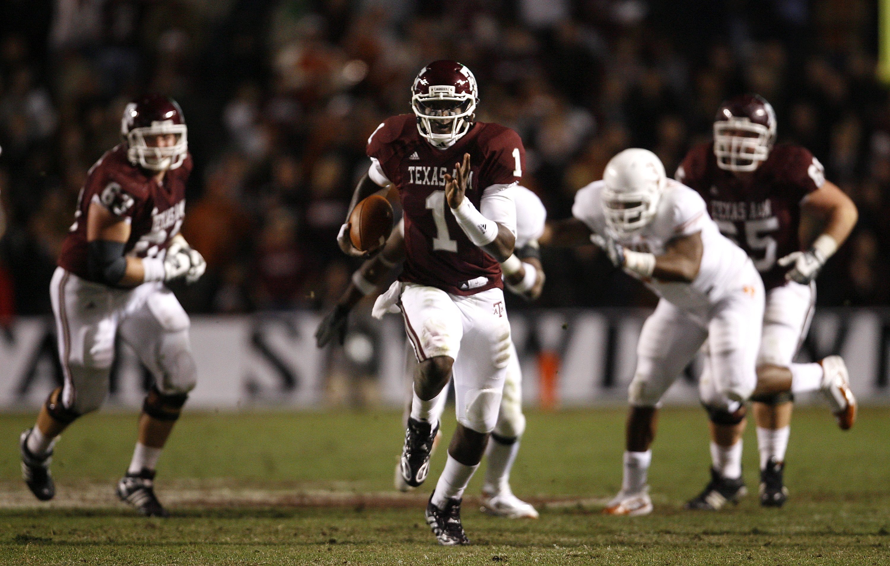 COLLEGE STATION, TX - NOVEMBER 26: Quarterback Jerrod Johnson #1 of the Texas A&M Aggies scrambles for a gain against the Texas Longhorns in the second half at Kyle Field on November 26, 2009 in College Station, Texas. The Longhorns defeated the Aggies 49