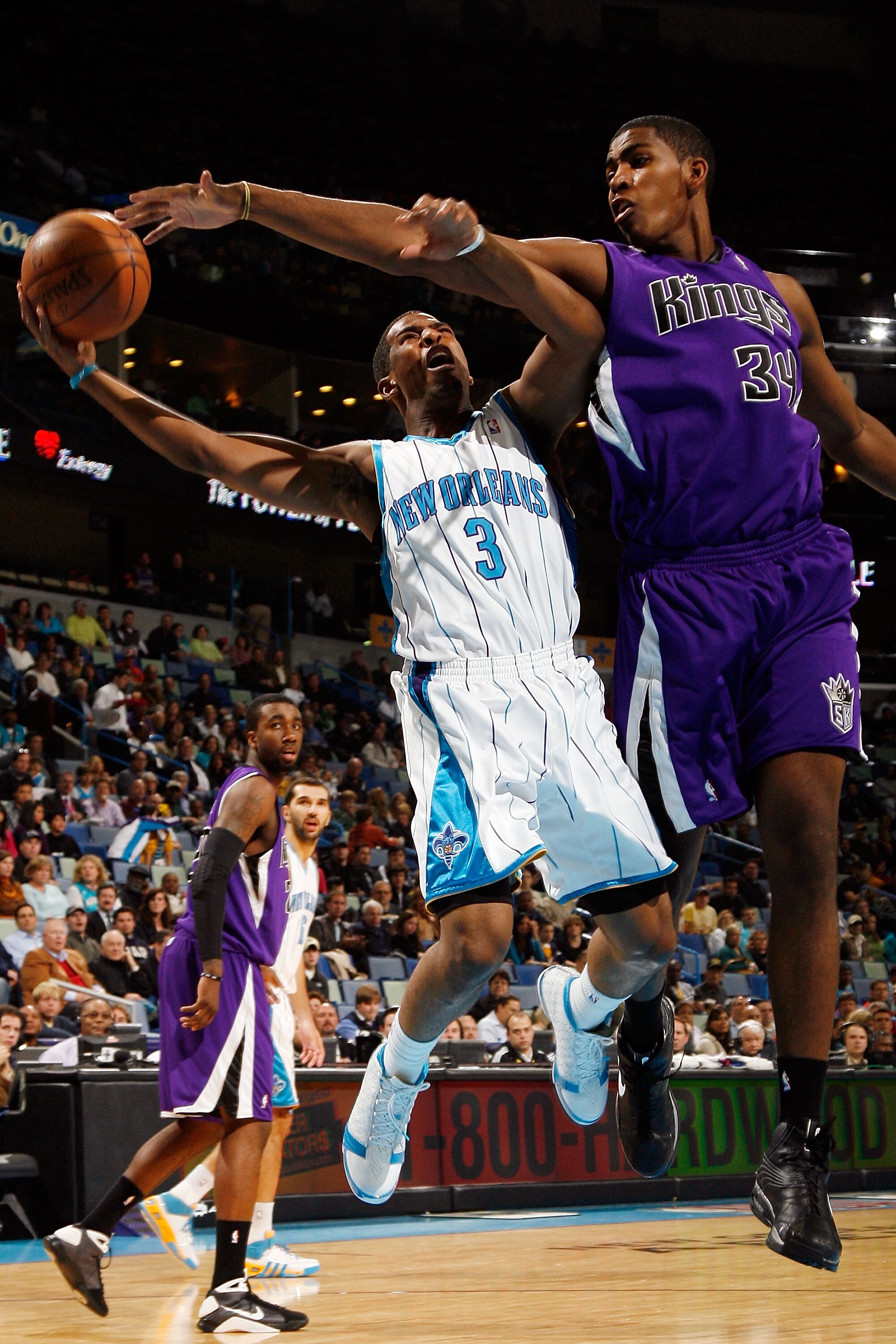 NEW ORLEANS - NOVEMBER 19:  Chris Paul #3 of the New Orleans Hornets makes a shot around Jason Thompson #34 of the Sacramento Kings at the New Orleans Arena on November 19, 2008 in New Orleans, Louisiana.  NOTE TO USER: User expressly acknowledges and agr