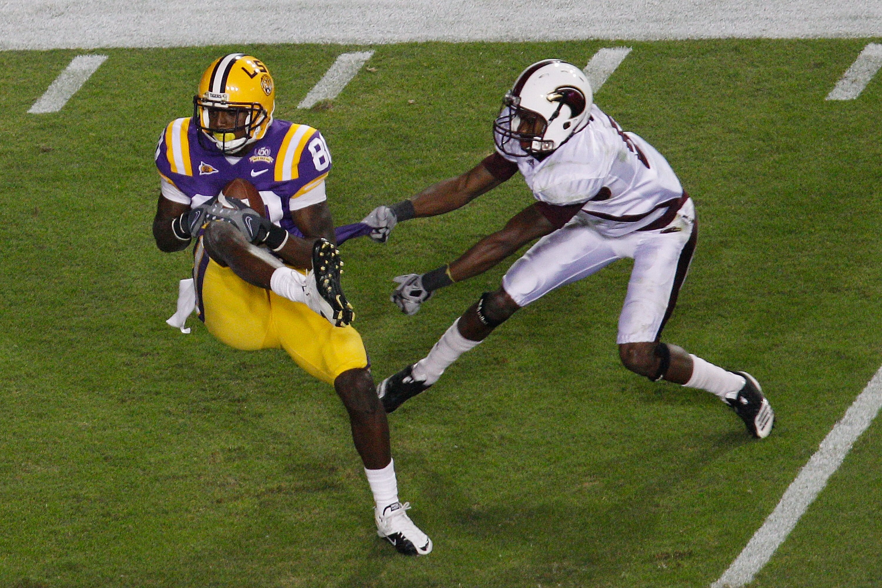 BATON ROUGE, LA - NOVEMBER 13:  Terrence Toliver #80 of the Louisiana State University Tigers makes a catch over Otis Peterson #9 of the University of Louisiana-Monroe Warhawks at Tiger Stadium on November 13, 2010 in Baton Rouge, Louisiana.   The Tigers 