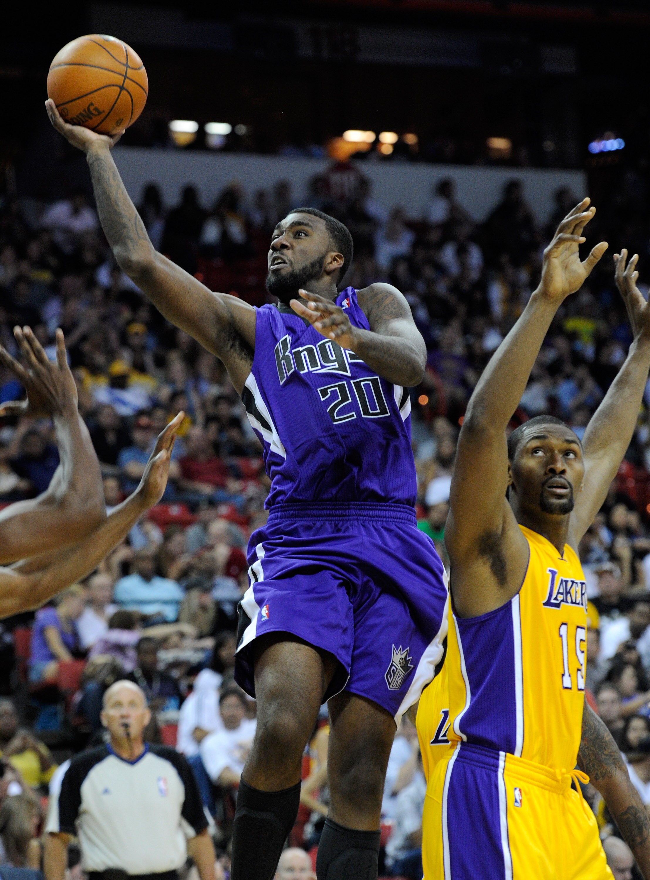LAS VEGAS - OCTOBER 13:  Donte Greene #20 of the Sacramento Kings drives past Ron Artest #15 of the Los Angeles Lakers during their preseason game at the Thomas & Mack Center October 13, 2010 in Las Vegas, Nevada. The Lakers won 98-95. NOTE TO USER: User