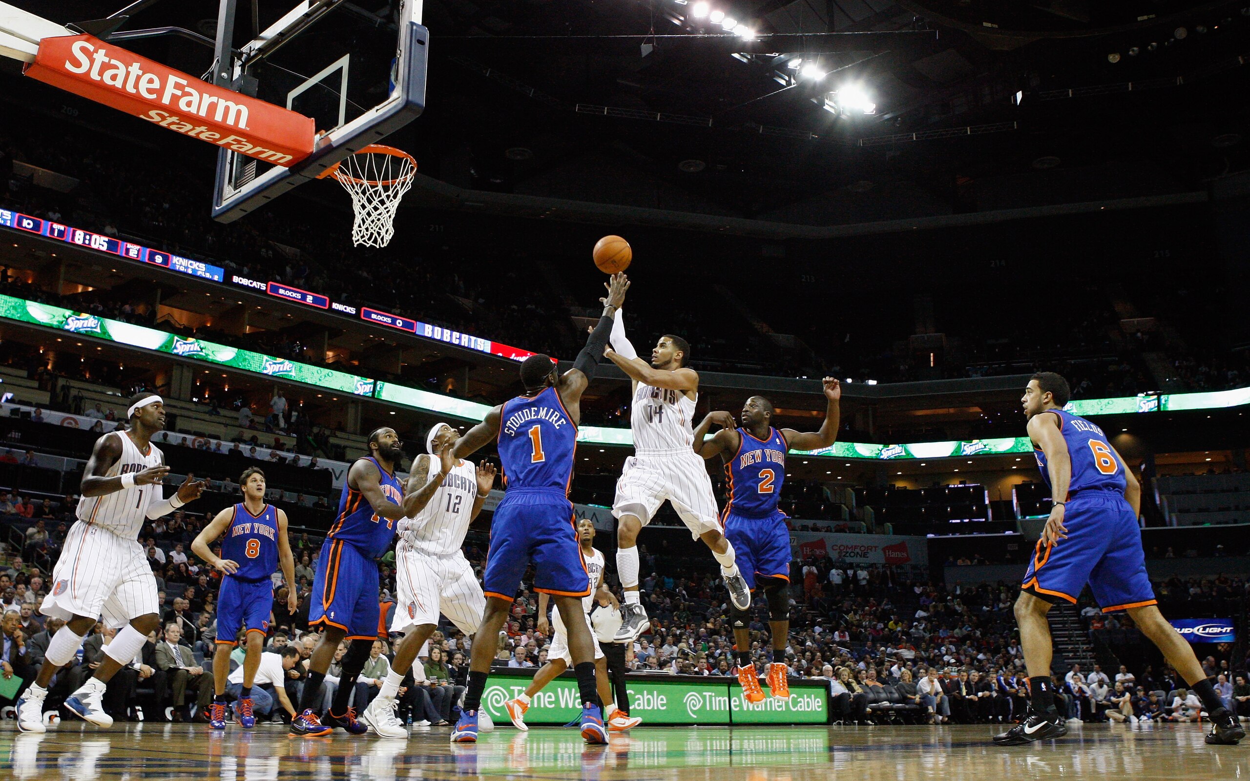 CHARLOTTE, NC - NOVEMBER 24: Amare Stoudemire #1 of the New York Knicks watches as D.J. Augustin #14 of the Charlotte Bobcats puts up a shot in the lane during their game at Time Warner Cable Arena on November 24, 2010 in Charlotte, North Carolina. NOTE CHARLOTTE, NC - NOVEMBER 24: Amare Stoudemire #1 of the New York Knicks watches as D.J. Augustin #14 of the Charlotte Bobcats puts up a shot in the lane during their game at Time Warner Cable Arena on November 24, 2010 in Charlotte, North Carolina. NOTE