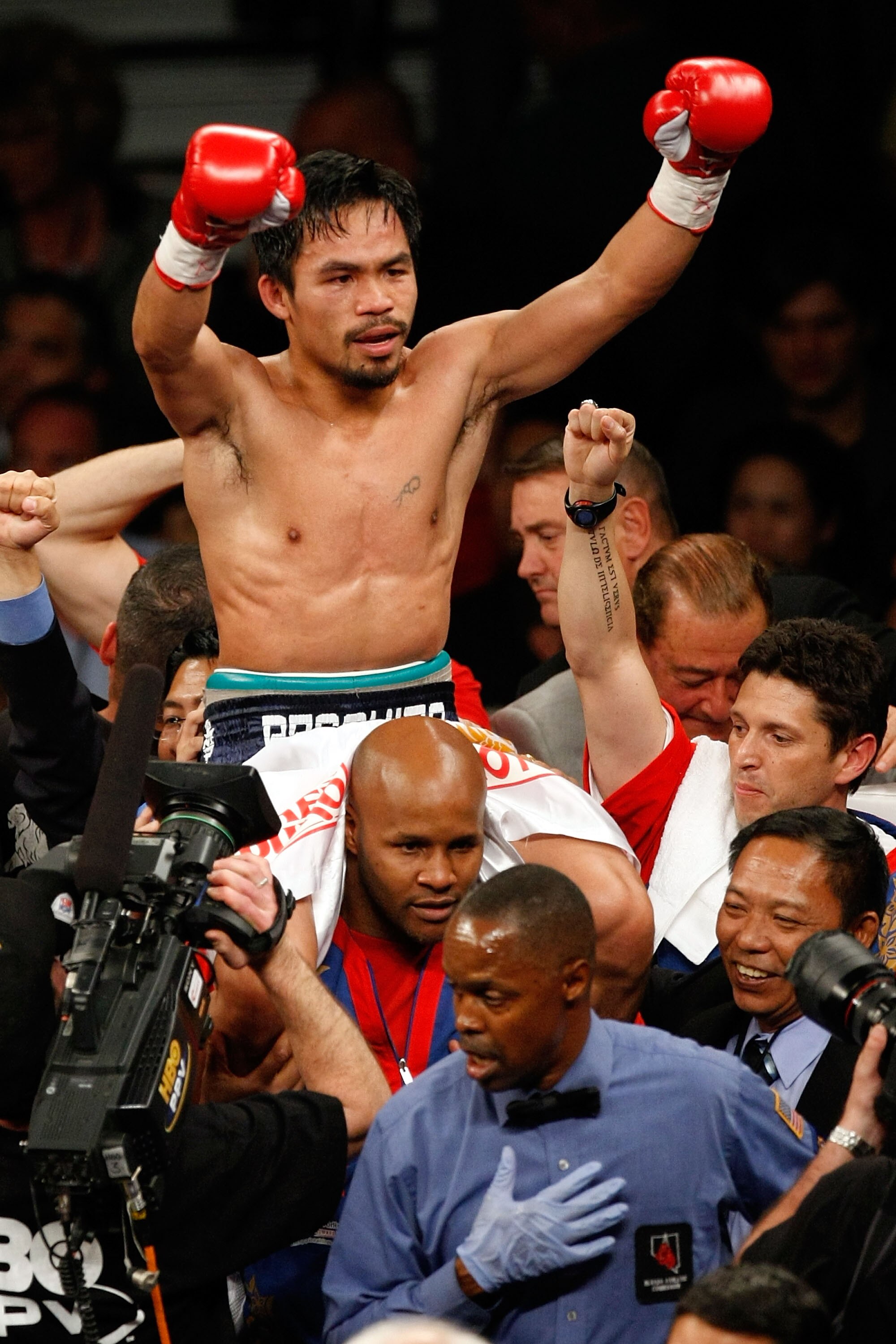 LAS VEGAS - MAY 02:  Manny Pacquiao of the Philippines celebrates after knocking down Ricky Hatton of England in the second round during their junior welterweight title fight at the MGM Grand Garden Arena May 2, 2009 in Las Vegas, Nevada.  (Photo by Ethan
