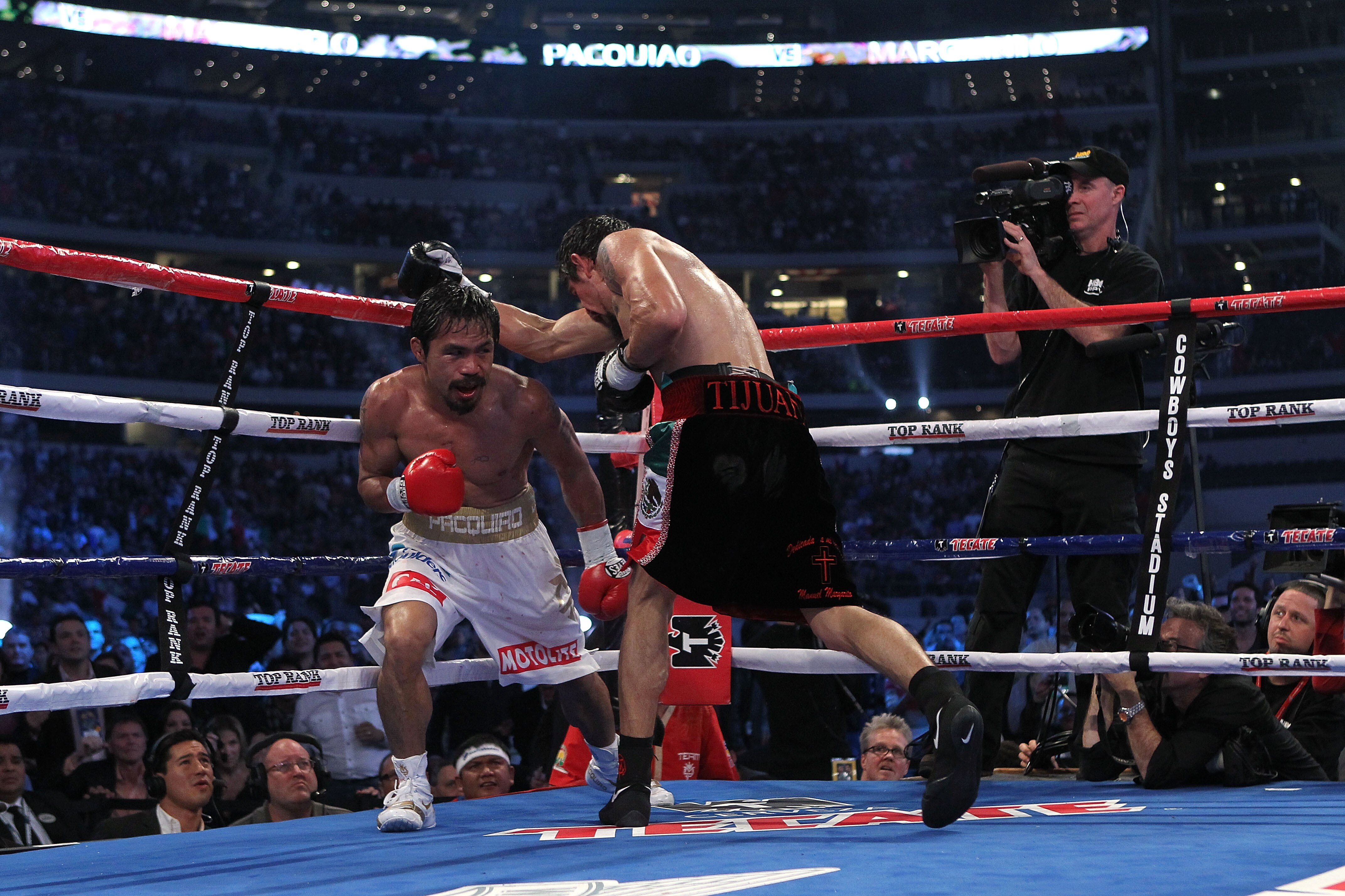ARLINGTON, TX - NOVEMBER 13:  Manny Pacquiao (white trunks) of the Philippines fights against Antonio Margarito (black trunks) of Mexico during their WBC World Super Welterweight Title bout at Cowboys Stadium on November 13, 2010 in Arlington, Texas.  (Ph