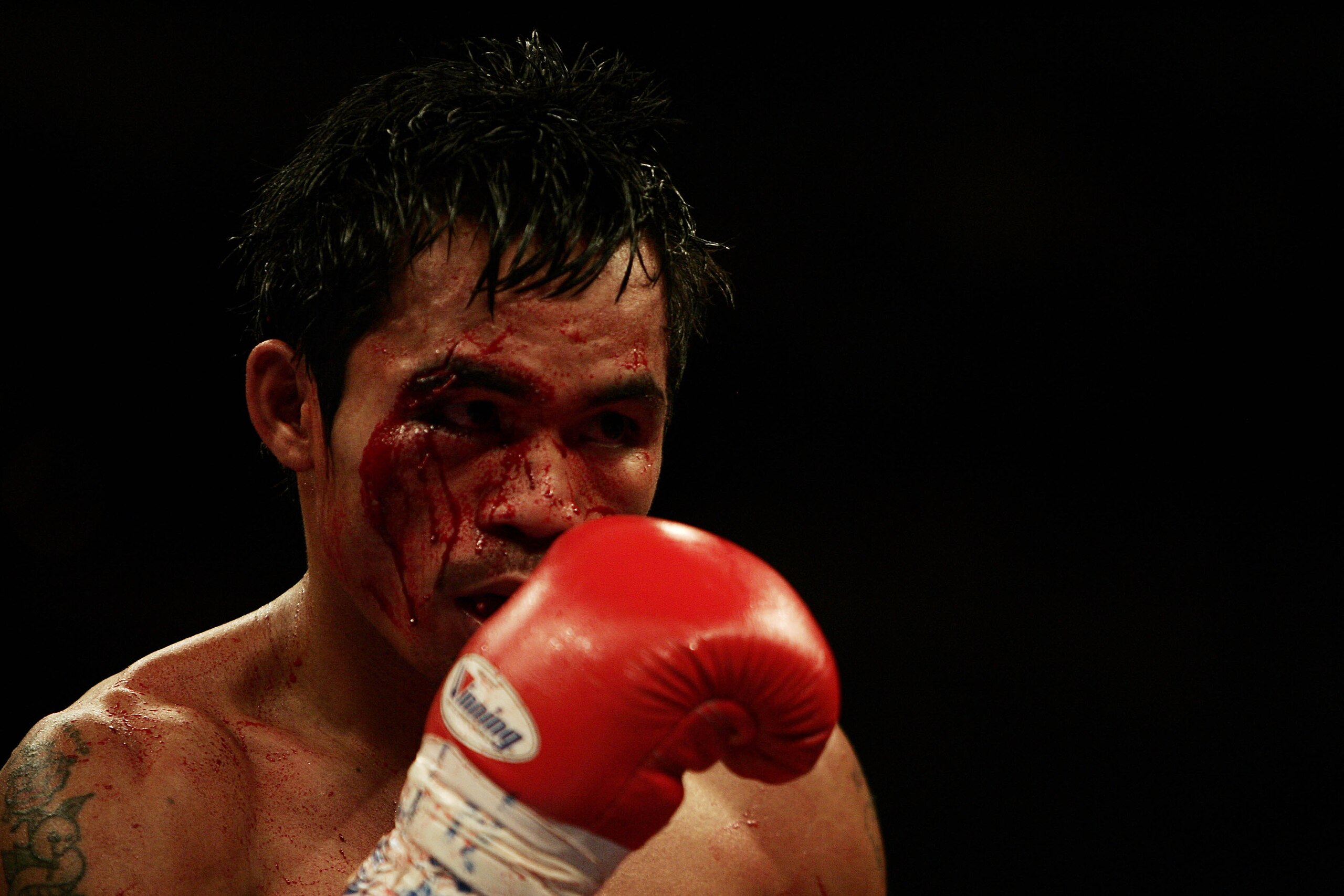 LAS VEGAS - MARCH 19: Manny Pacquiao of the Philippines is shown with a cut above his right eye inflicted by Erik Morales of Mexico during the World Super Featherweight Championship at the MGM Grand Hotel on March 19, 2005 in Las Vegas, Nevada. Erik Mor LAS VEGAS - MARCH 19: Manny Pacquiao of the Philippines is shown with a cut above his right eye inflicted by Erik Morales of Mexico during the World Super Featherweight Championship at the MGM Grand Hotel on March 19, 2005 in Las Vegas, Nevada. Erik Mor
