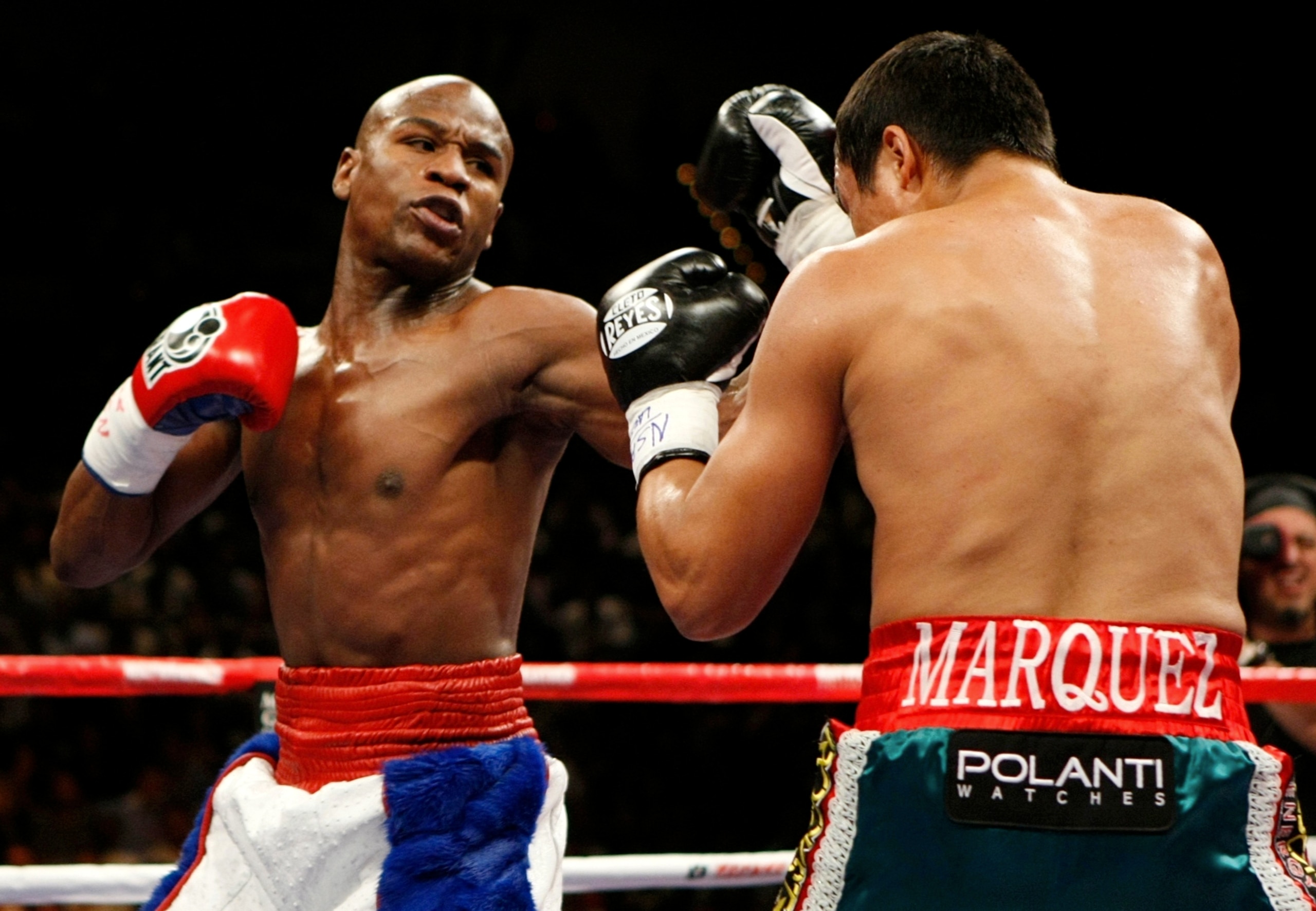 LAS VEGAS - SEPTEMBER 19: (L-R) Floyd Mayweather Jr. throws a left to the body of Juan Manuel Marquez of Mexico during their welterweight bout at the MGM Grand Garden Arena September 19, 2009 in Las Vegas, Nevada. (Photo by Ethan Miller/Getty Images) LAS VEGAS - SEPTEMBER 19: (L-R) Floyd Mayweather Jr. throws a left to the body of Juan Manuel Marquez of Mexico during their welterweight bout at the MGM Grand Garden Arena September 19, 2009 in Las Vegas, Nevada. (Photo by Ethan Miller/Getty Images)