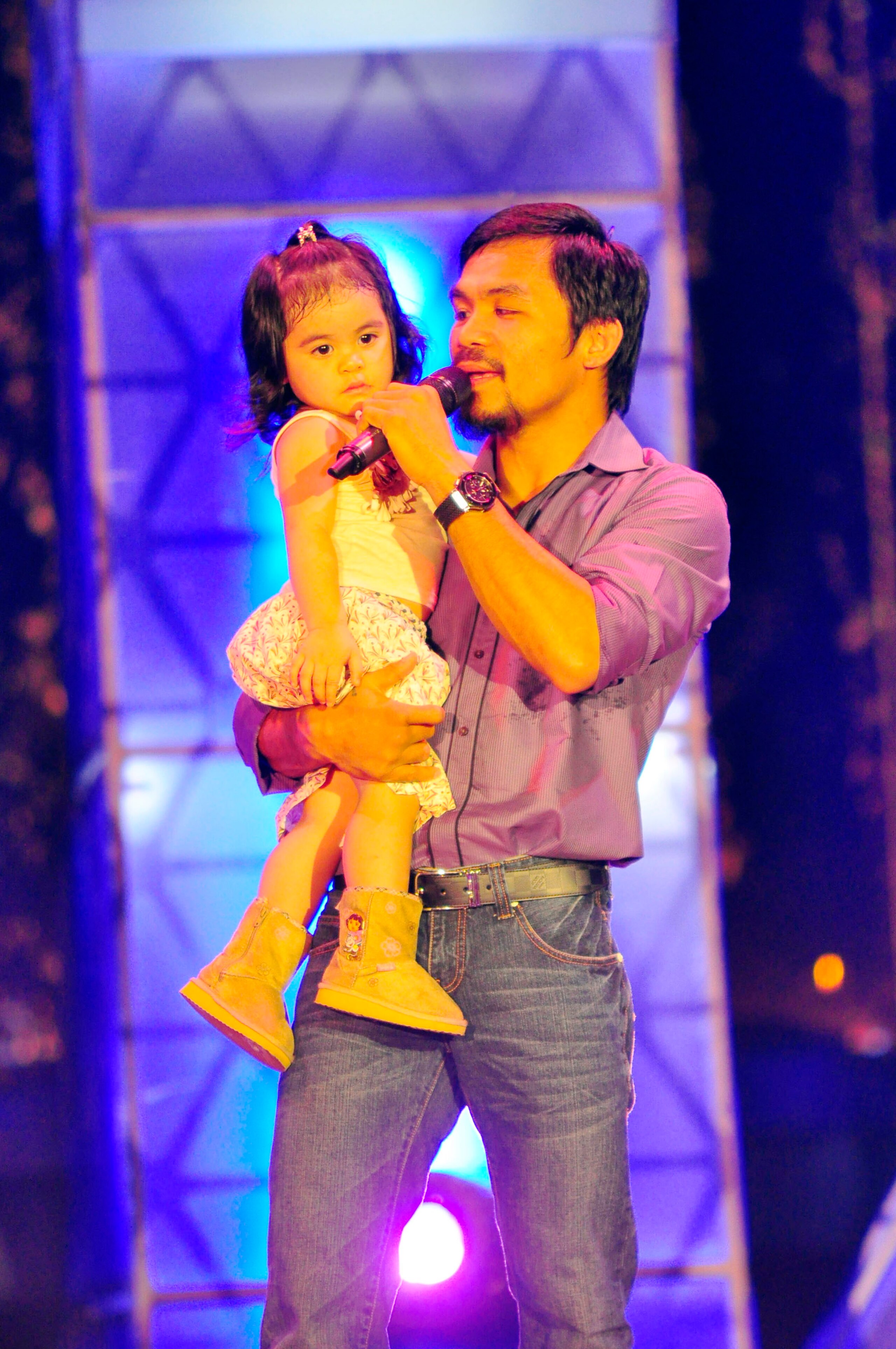 MANILA, PHILIPPINES - NOVEMBER 20: Boxer and congressman, Manny Pacquiao sings with youngest daughter Queen Elizabeth during his concert in Manila following his win of the WBC super welterweight crown against Mexican Antonio Margarito on November 20, 201 MANILA, PHILIPPINES - NOVEMBER 20: Boxer and congressman, Manny Pacquiao sings with youngest daughter Queen Elizabeth during his concert in Manila following his win of the WBC super welterweight crown against Mexican Antonio Margarito on November 20, 201