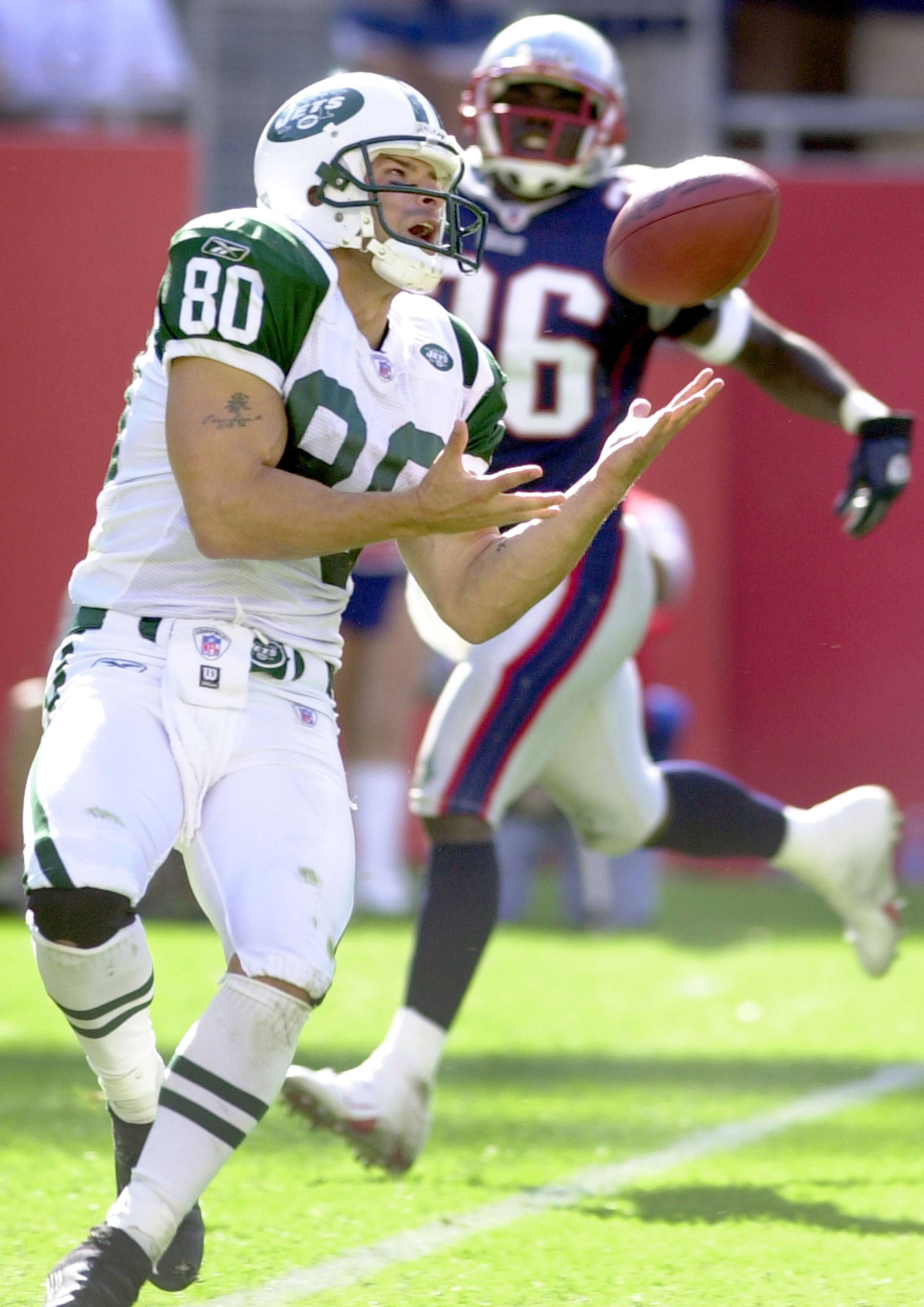 FOXBORO, MA - SEPTEMBER 21:  Wide receiver Wayne Chrebet #80 of the New York Jets catches a touchdown pass during game action against the New England Patriots September 21, 2003 at Gillette Stadium in Foxboro, Massachusetts. New England won 23-16.  (Photo