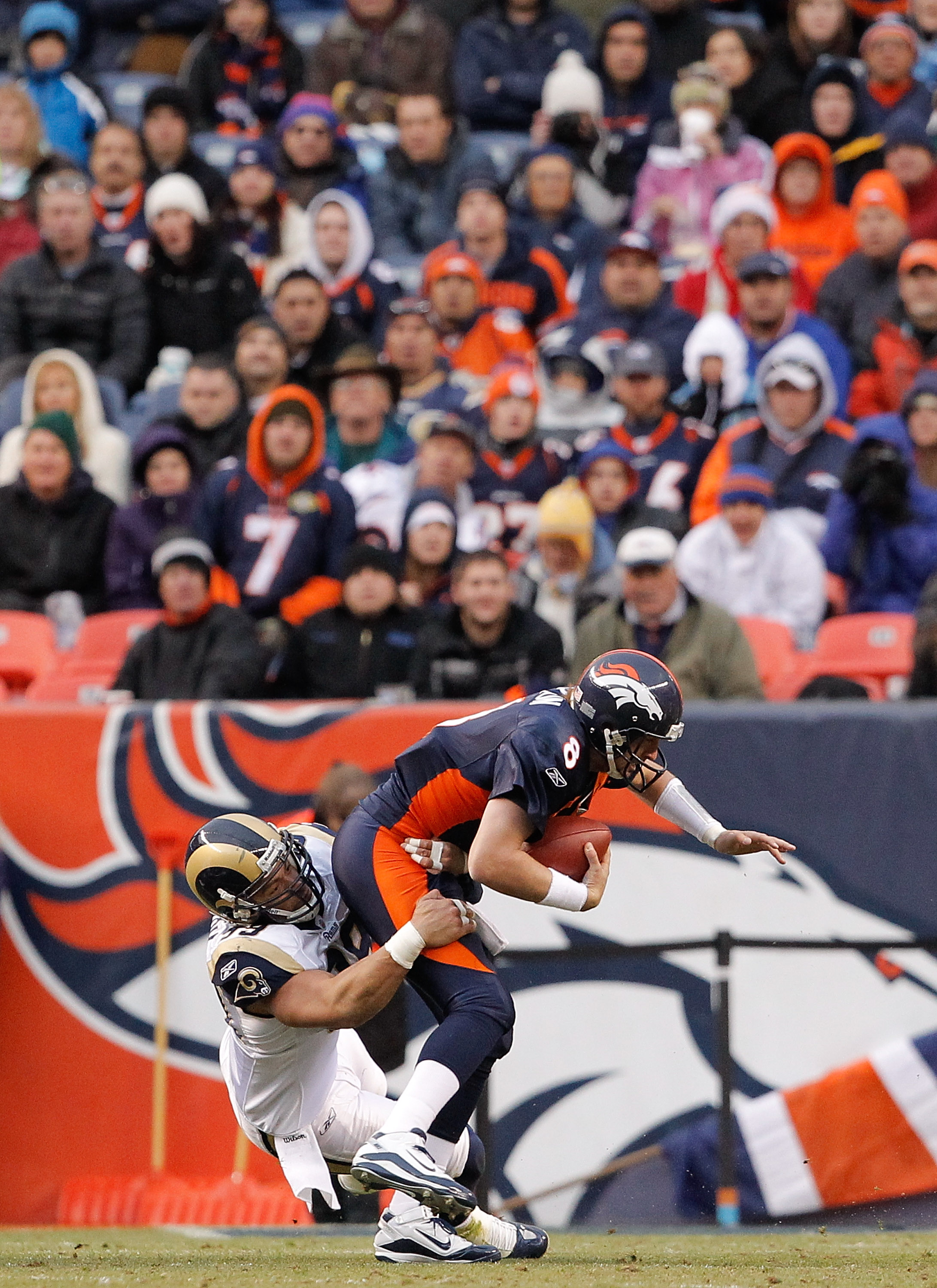 DENVER - NOVEMBER 28:  Defensive end C.J. Ah You #99 of the St. Louis Rams sacks quarterback Kyle Orton #8 of the Denver Broncos during the first quarter at INVESCO Field at Mile High on November 28, 2010 in Denver, Colorado. The Rams defeated the Broncos