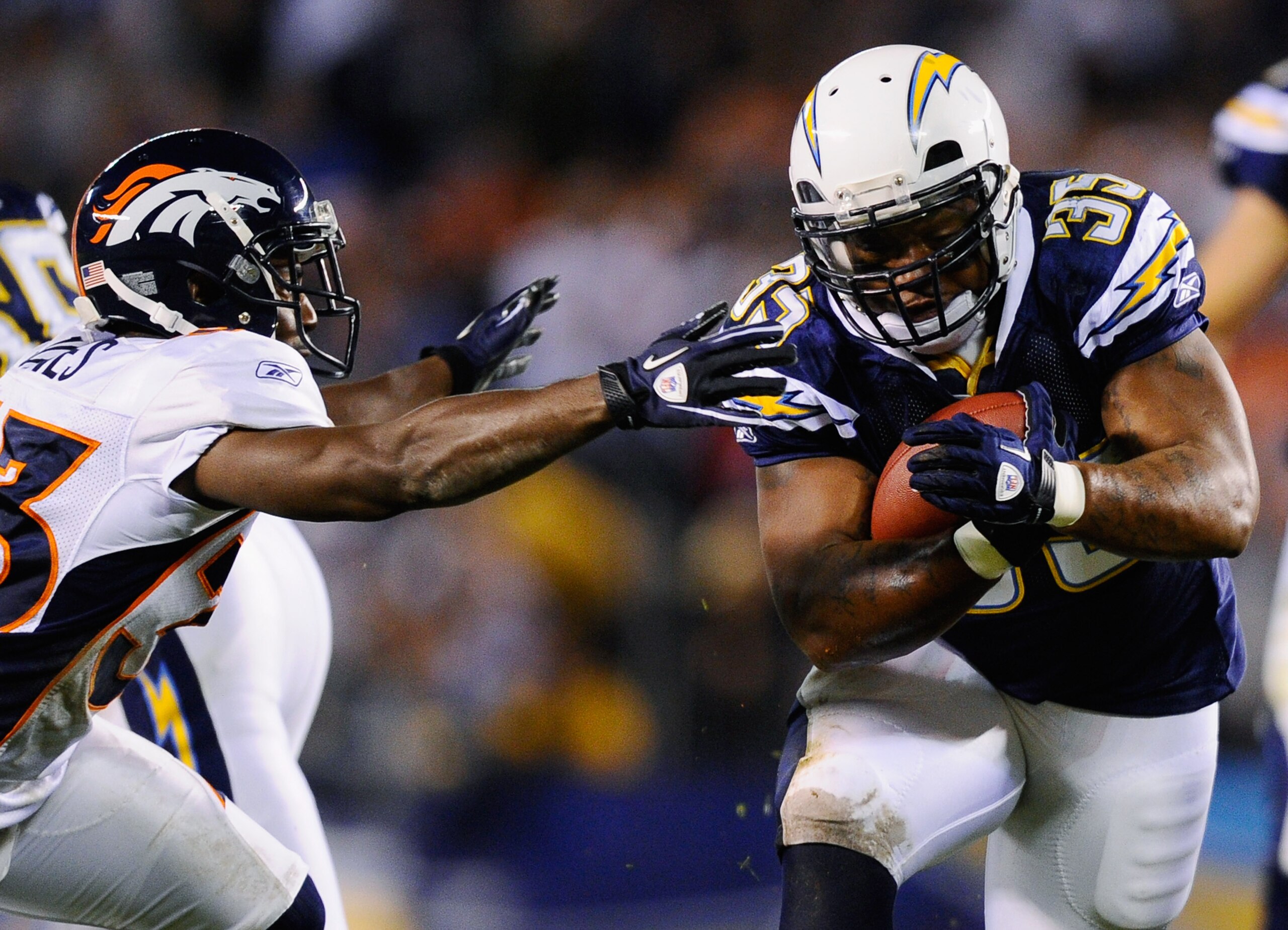 SAN DIEGO - NOVEMBER 22:  Mike Tolbert #35 of the San Diego Chargers breaks a tackle against Nate Jones #33 of the Denver Broncos as he rushes for a gain at Qualcomm Stadium on November 22, 2010 in San Diego, California.  (Photo by Kevork Djansezian/Getty