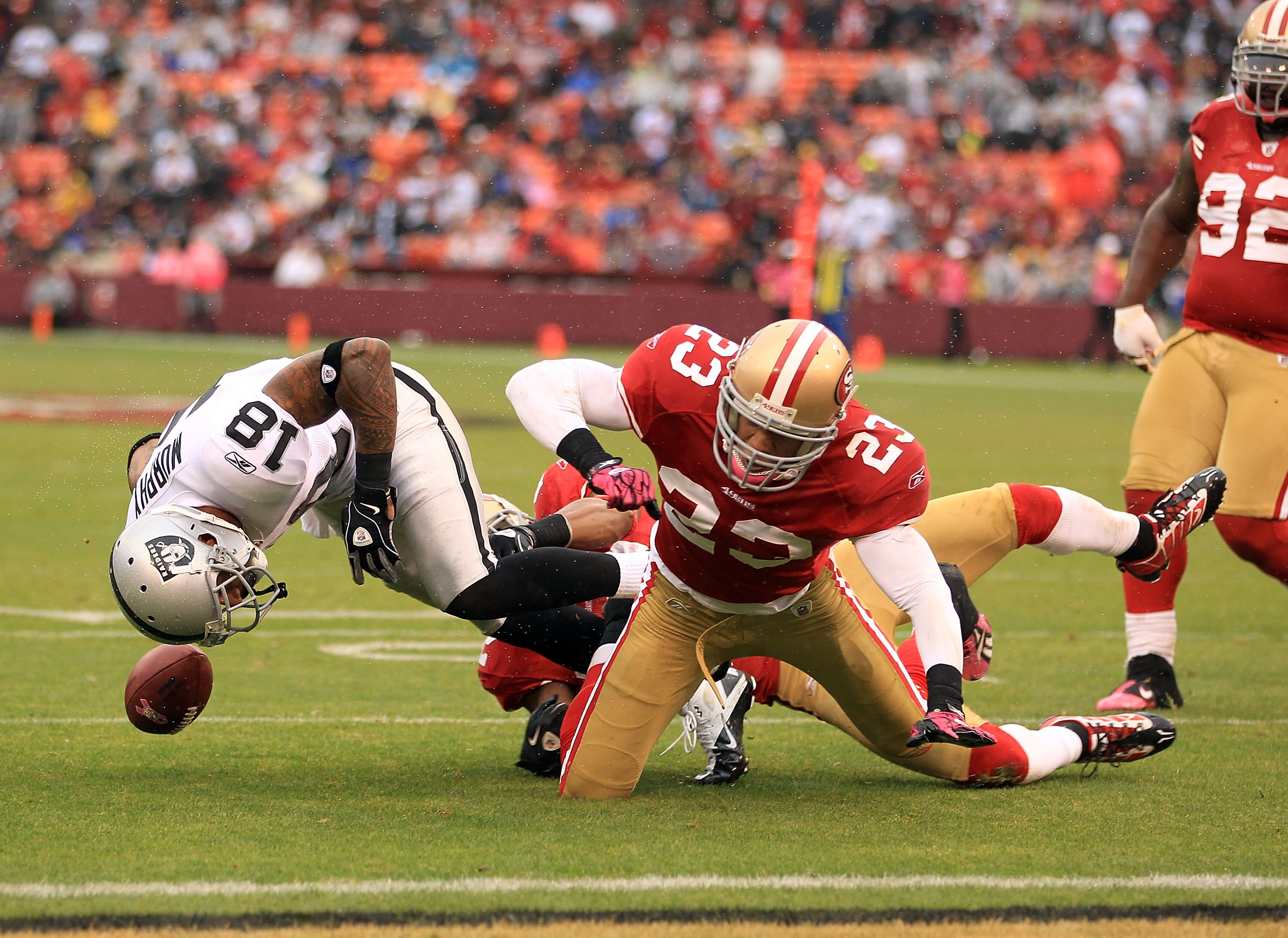 SAN FRANCISCO - OCTOBER 17:  Louis Murphy #18 of the Oakland Raiders fumbles the ball when he was hit by Taylor Mays #23 of the San Francisco 49ers at Candlestick Park on October 17, 2010 in San Francisco, California. Murphy recovered his own fumble on th