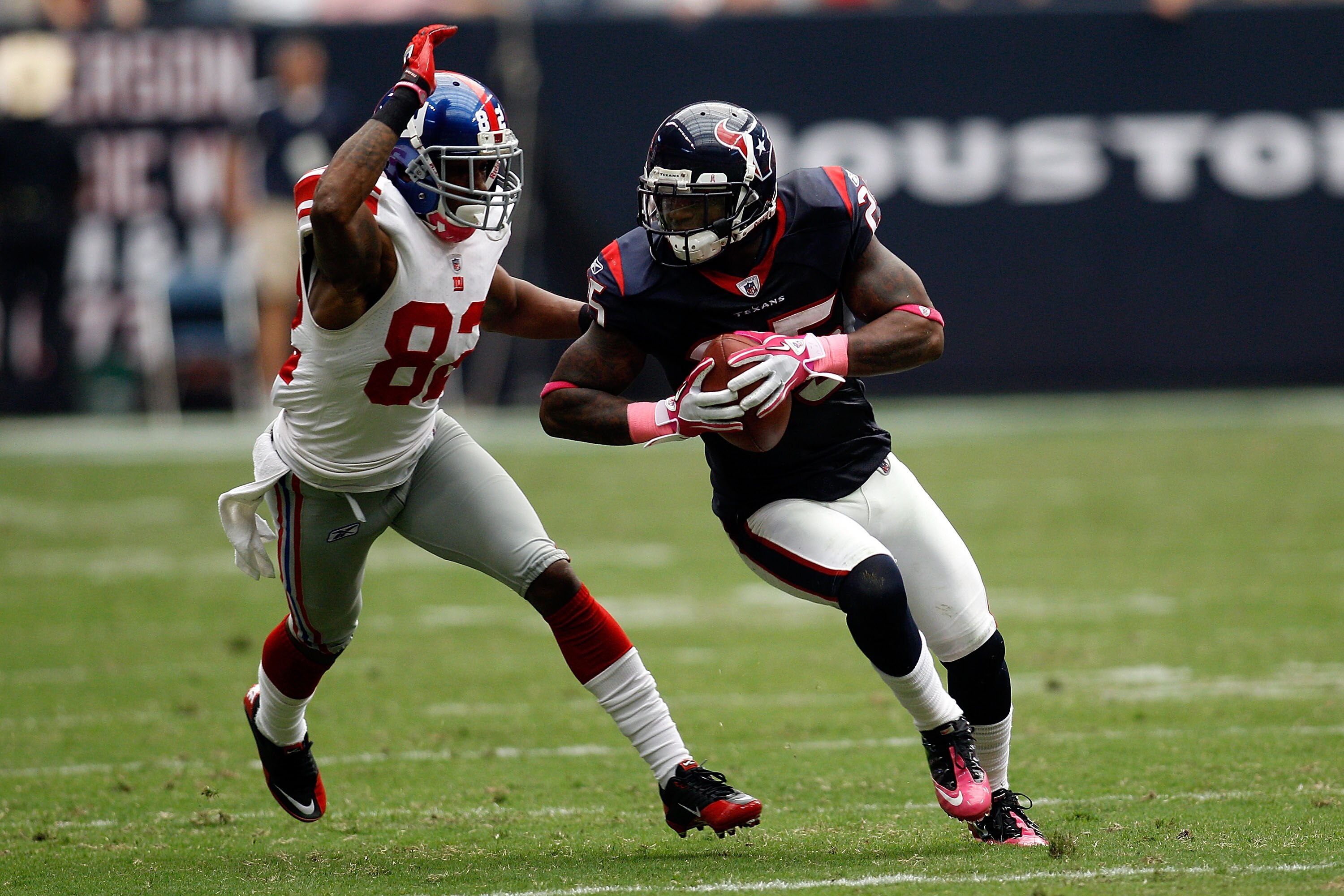 HOUSTON - OCTOBER 10:  Kareem Jackson #25 of the Houston Texans avoids a tackle after intercepting a pass  by Mario Manningham #82 of the New York Giants at Reliant Stadium on October 10, 2010 in Houston, Texas.  The Giants defeated the Texans 34-10.  (Ph