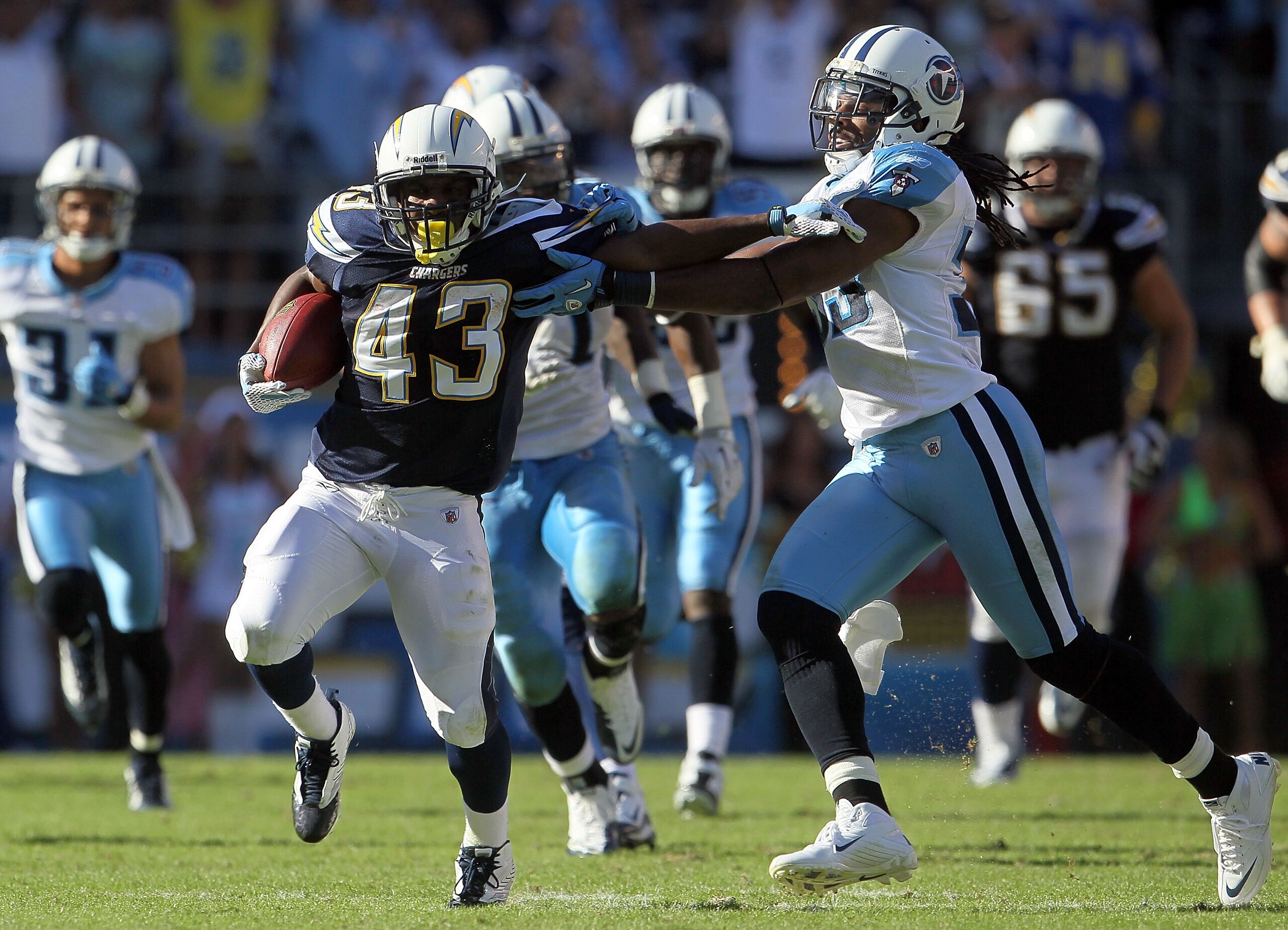 SAN DIEGO - OCTOBER 31:  Running back Darren Sproles #43 of the San Diego Chargers is pursued by Michael Griffin #33 of the Tennessee Titans in the game at Qualcomm Stadium on October 31, 2010 in San Diego, California. The Chargers defeated the Titans 33-
