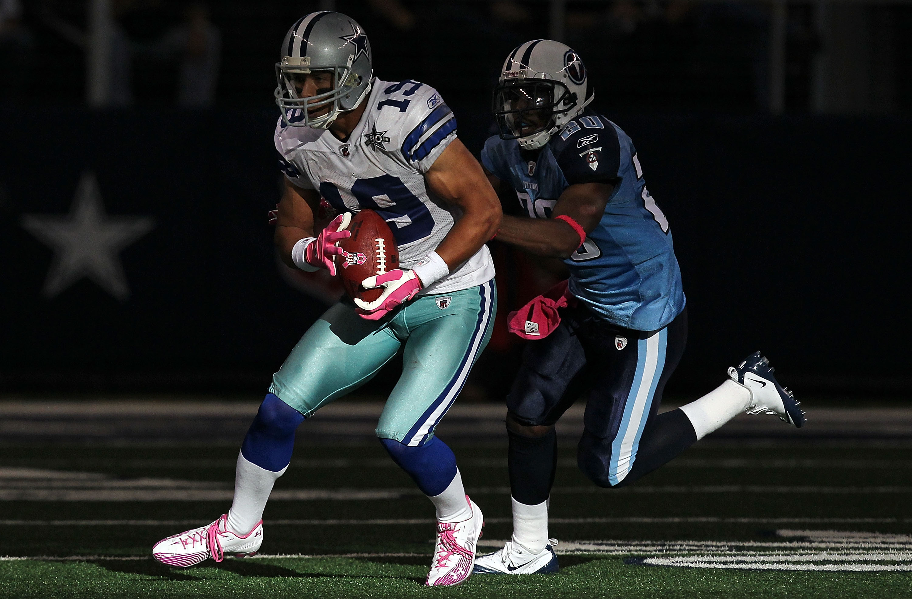 ARLINGTON, TX - OCTOBER 10:  Wide receiver Miles Austin #19 of the Dallas Cowboys runs the ball against Alterraun Verner #20 of the Tennessee Titans at Cowboys Stadium on October 10, 2010 in Arlington, Texas.  (Photo by Ronald Martinez/Getty Images)