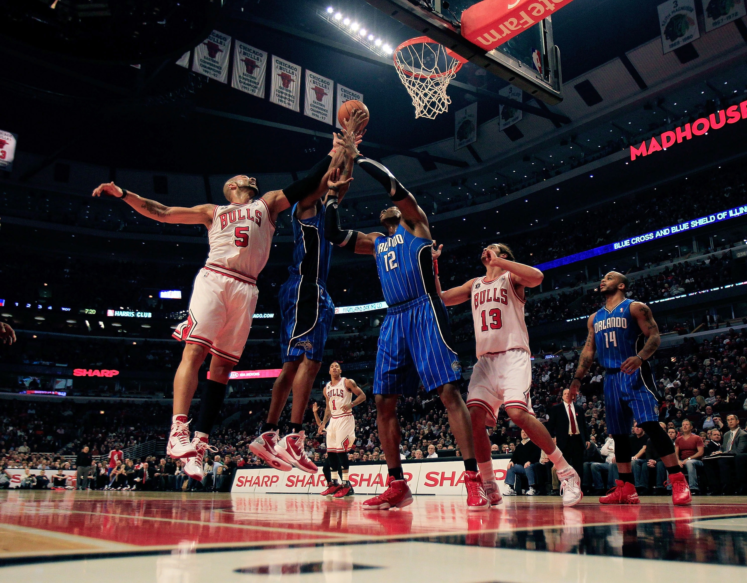 CHICAGO, IL - DECEMBER 01: Carlos Boozer #5 of the Chicago Bulls battles for a rebound with Rashard Lewis #9 and Dwight Howard #12 of the Orlando Magic while Joakin Noah #13 sets up at the United Center on December 1, 2010 in Chicago, Illinois. NOTE TO US CHICAGO, IL - DECEMBER 01: Carlos Boozer #5 of the Chicago Bulls battles for a rebound with Rashard Lewis #9 and Dwight Howard #12 of the Orlando Magic while Joakin Noah #13 sets up at the United Center on December 1, 2010 in Chicago, Illinois. NOTE TO US
