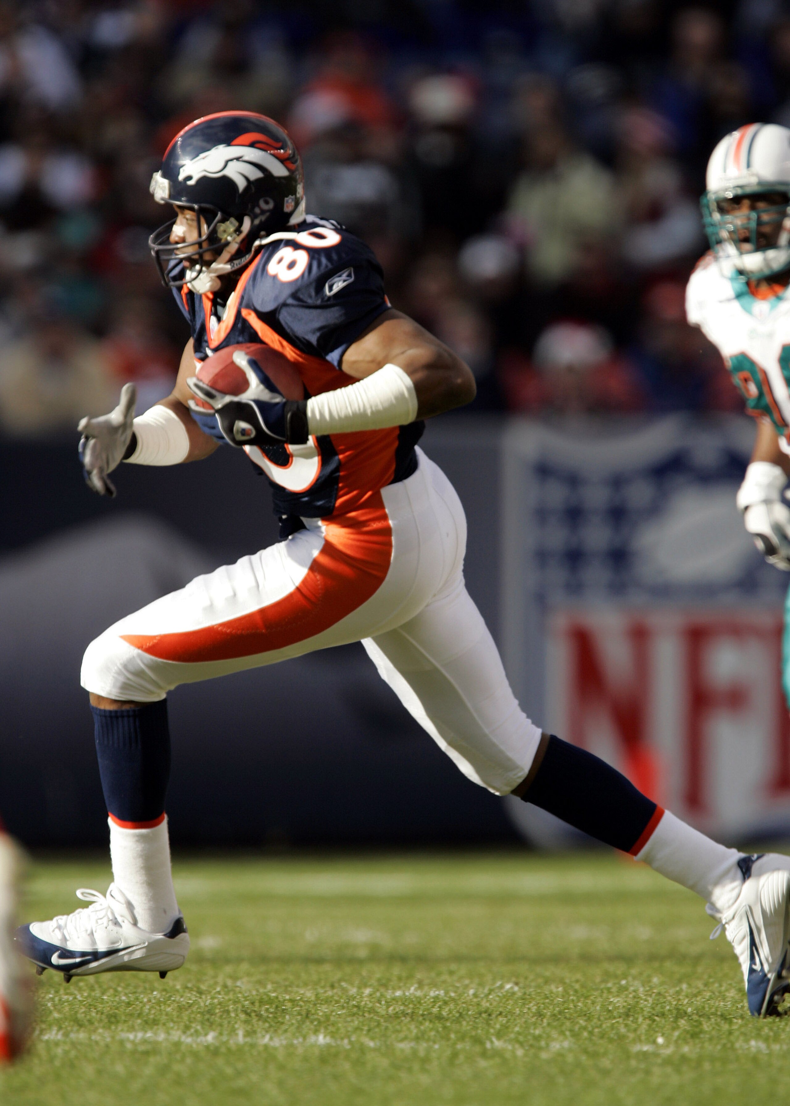DENVER - DECEMBER 12:  Wide receiver Rod Smith #80 of the Denver Broncos catches a pass against the Miami Dolphins in the first quarter on December 12, 2004 at Invesco Field at Mile High Stadium in Denver, Colorado.  Smith had eight catches for 97 yards i