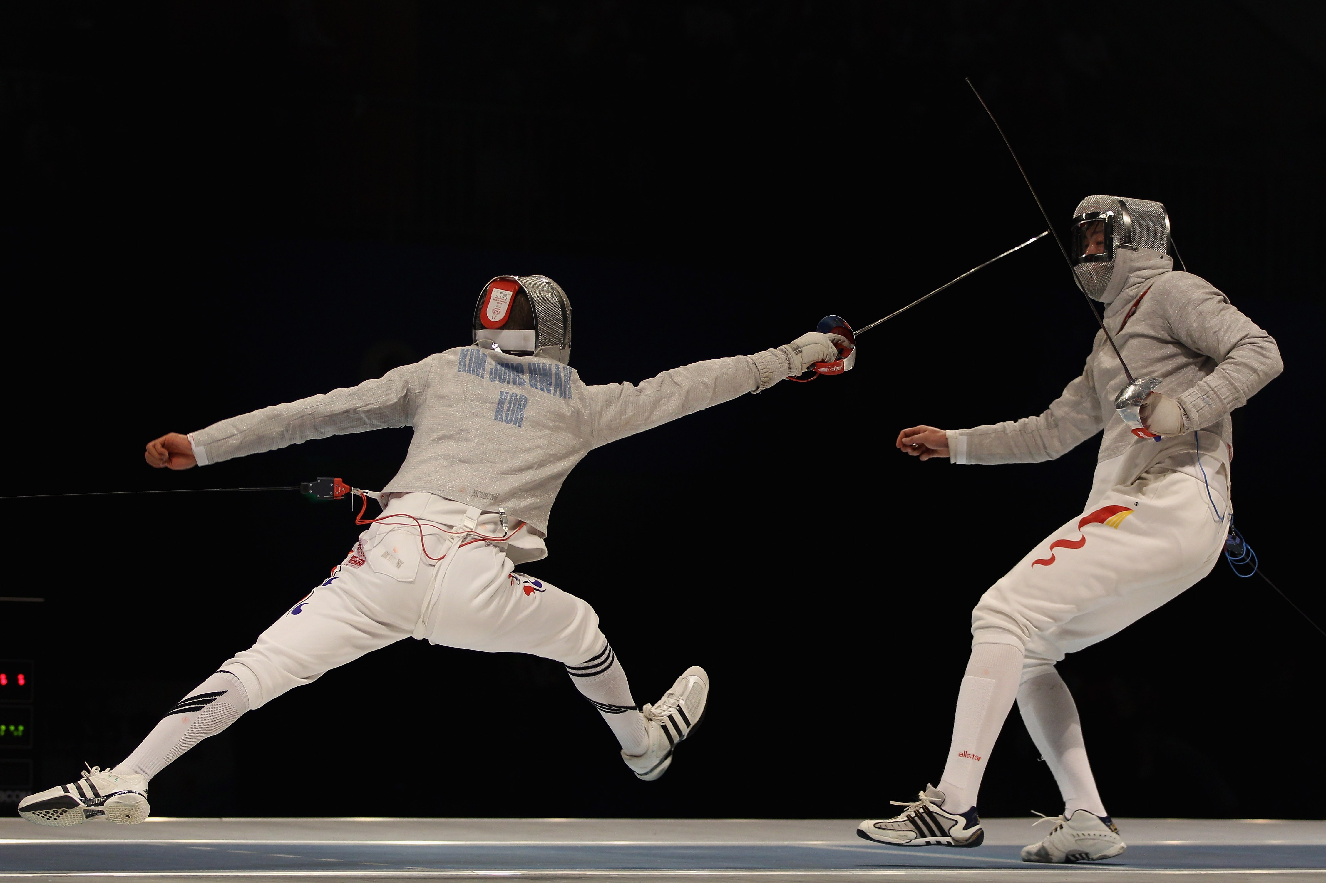 GUANGZHOU, CHINA - NOVEMBER 22:  Jung Hwan Kim of South Korea competes in the Men's Team Sabre Final against Jingzhi Wang of  China at Guangda Gymnasium during day ten of the 16th Asian Games Guangzhou 2010 on November 22, 2010 in Guangzhou, China.  (Phot