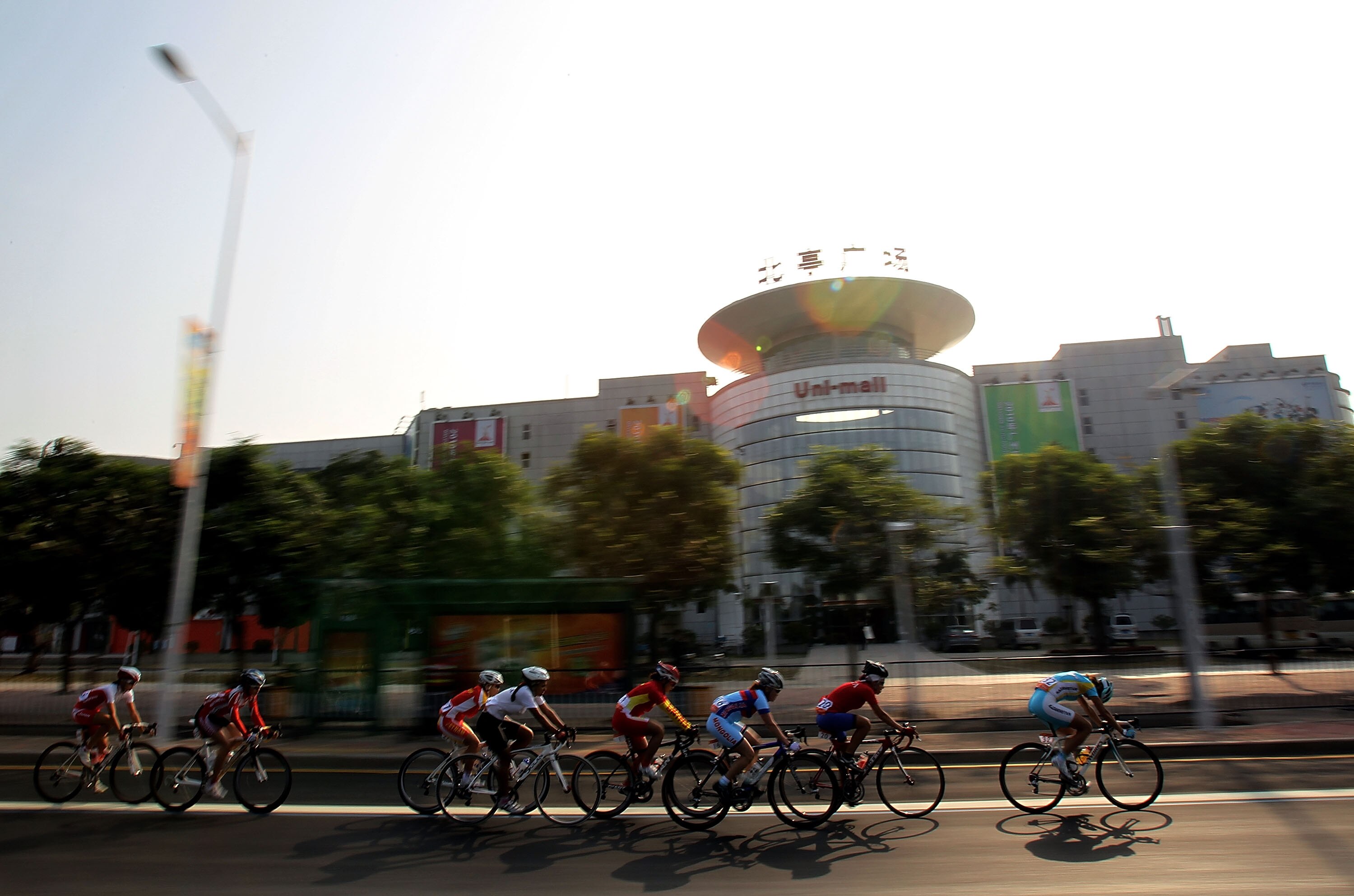 GUANGZHOU, CHINA - NOVEMBER 23:  The peloton cycles during the Women's Individual Road Race of road cycling at Triathlon Venue on November 23, 2010 in Guangzhou, China.  (Photo by Ronald Martinez/Getty Images)