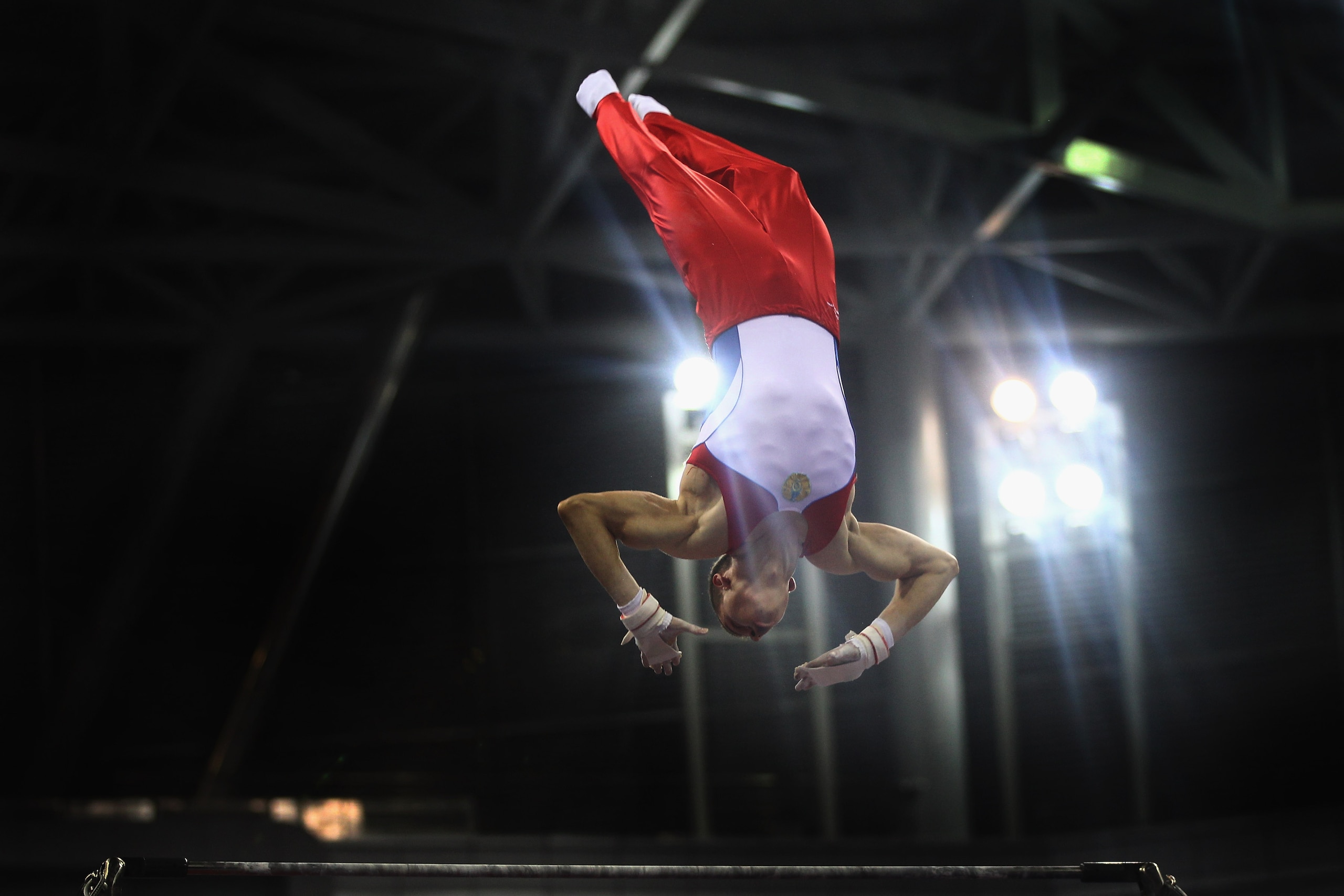 GUANGZHOU, CHINA - NOVEMBER 17: Stepan Gorbachev of Kazakhstan competes in the Men's Horizontal bars final during the artistic gymnastics on day five of the 16th Asian Games Guangzhou 2010 at Asian Games Town Gymnasium on November 17, 2010 in Guangzhou, GUANGZHOU, CHINA - NOVEMBER 17: Stepan Gorbachev of Kazakhstan competes in the Men's Horizontal bars final during the artistic gymnastics on day five of the 16th Asian Games Guangzhou 2010 at Asian Games Town Gymnasium on November 17, 2010 in Guangzhou,