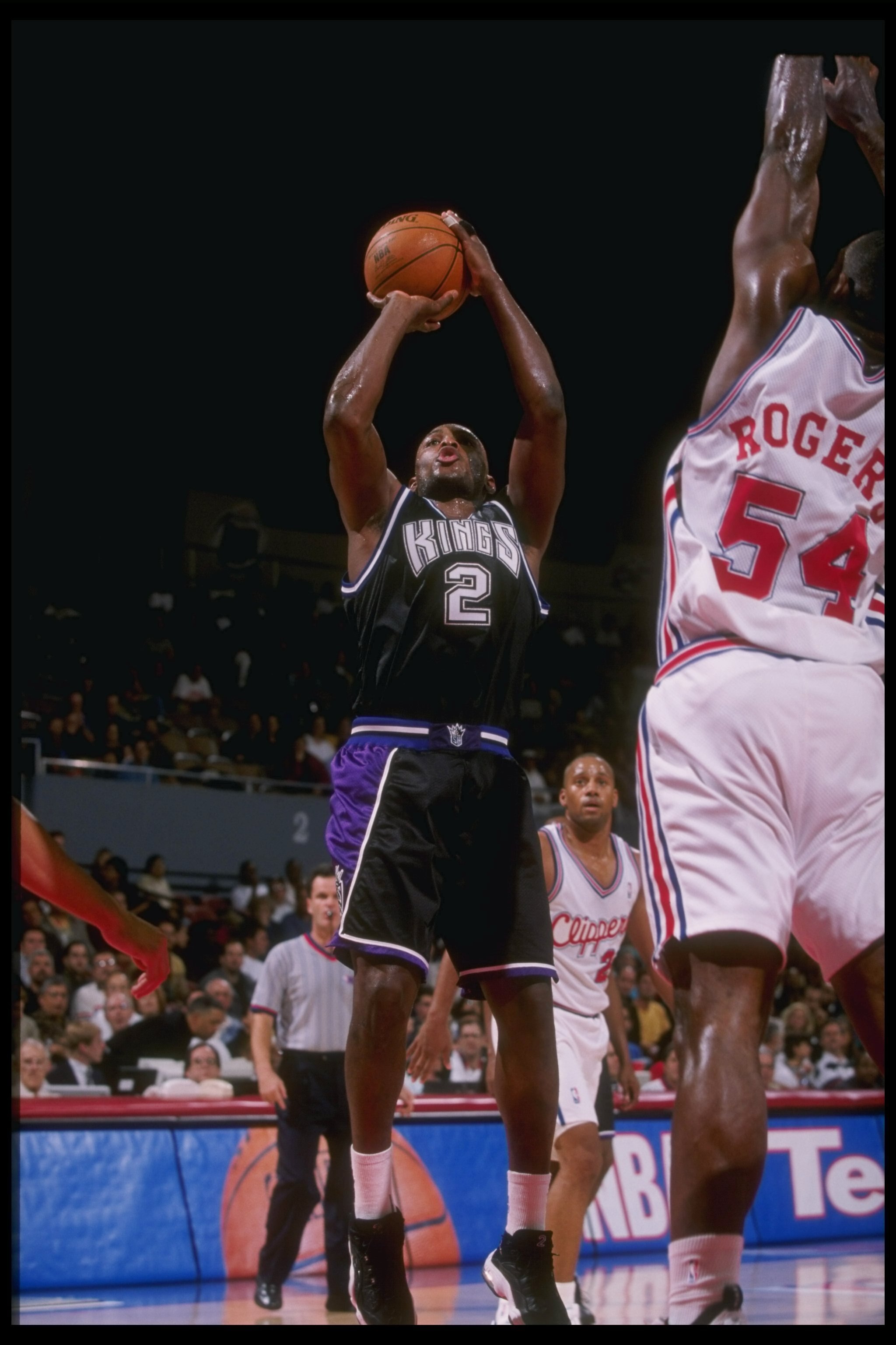 26 Nov 1997: Guard Mitch Richmond of the Sacramento Kings shoots the ball over forward Rodney Rodgers of the Los Angeles Clippers during a game at the Los Angeles Sports Arena in Los Angeles, California. The Clippers won the game 99-97.
