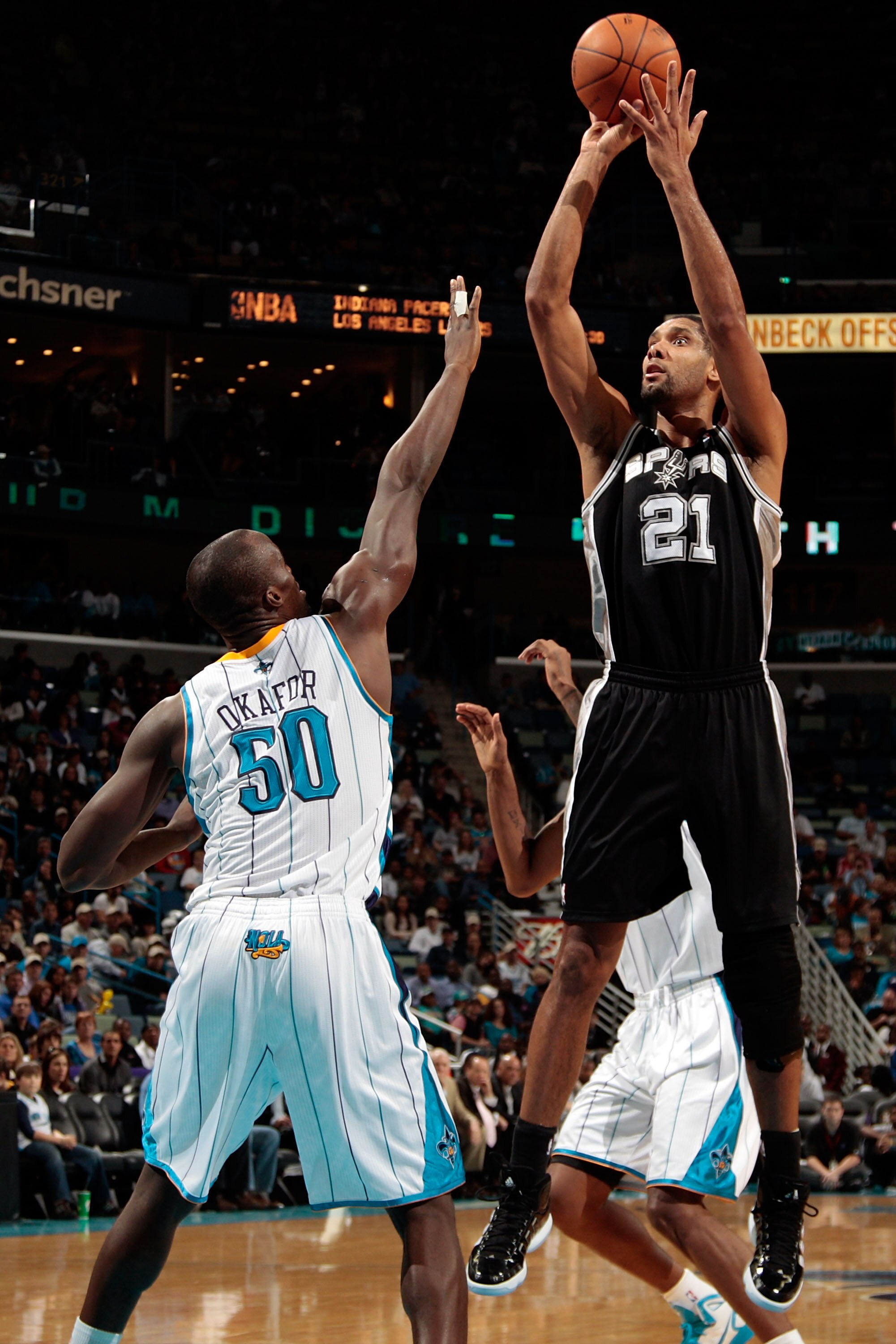 NEW ORLEANS - NOVEMBER 28:  Tim Duncan #21 of the San Antonio Spurs shoots the ball over Emeka Okafor #50 of the New Orleans Hornets at the New Orleans Arena on November 28, 2010 in New Orleans, Louisiana.  The Spurs defeated the Hornets 109-95.  NOTE TO