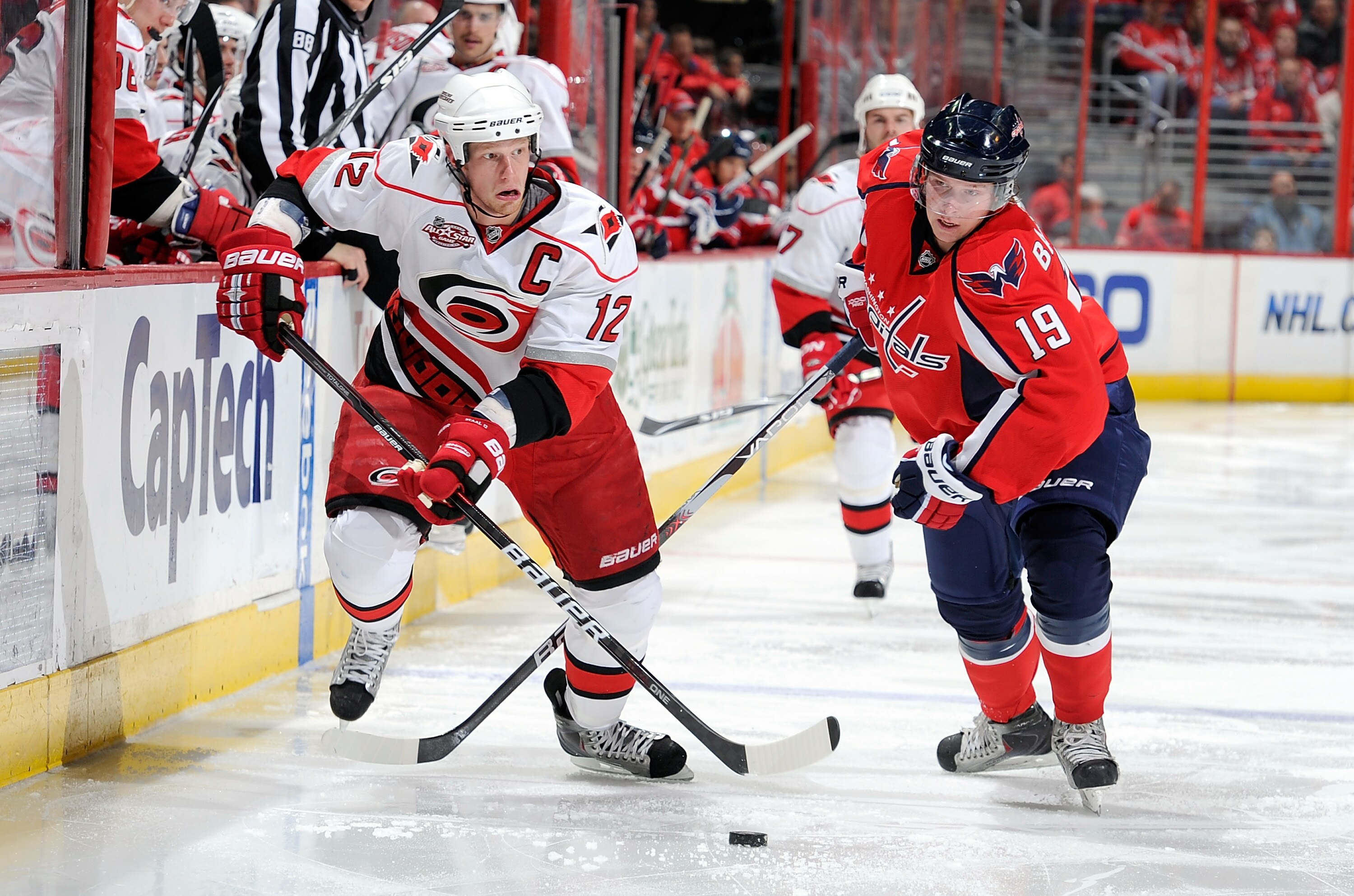 WASHINGTON - NOVEMBER 28:  Eric Staal #12 of the Carolina Hurricanes brings the puck down the ice against Nicklas Backstrom #19 of the Washington Capitals at the Verizon Center on November 28, 2010 in Washington, DC.  (Photo by Greg Fiume/Getty Images)