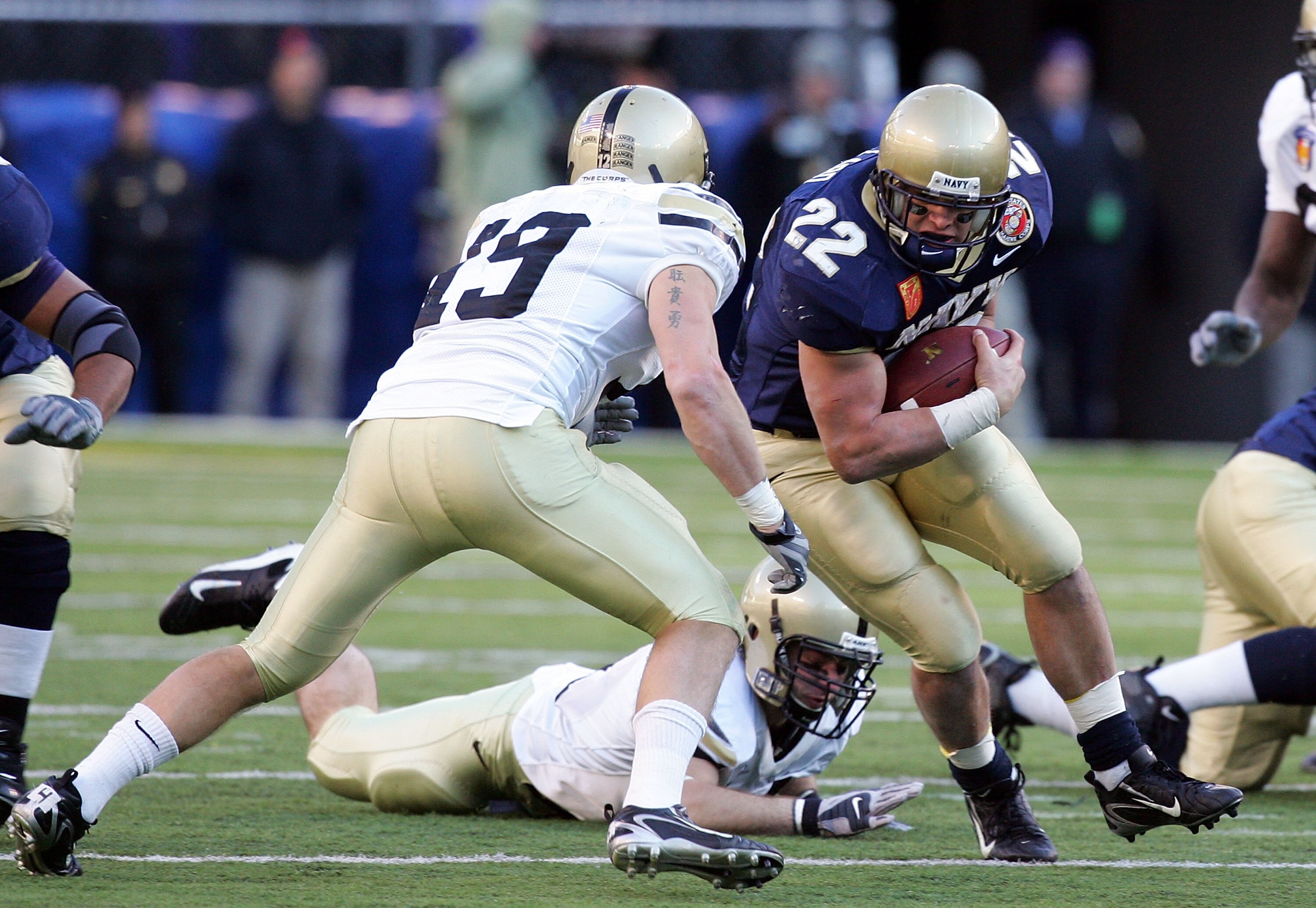 BALTIMORE - DECEMBER 01:  Adam Ballard #22 of the Navy Midshipmen runs the ball against Jordan Murray #19 of the Army Black Knights during the 108th Army v Navy football game on December 1, 2007 at M&T Bank Stadium in Baltimore, Maryland.  (Photo by Jim M