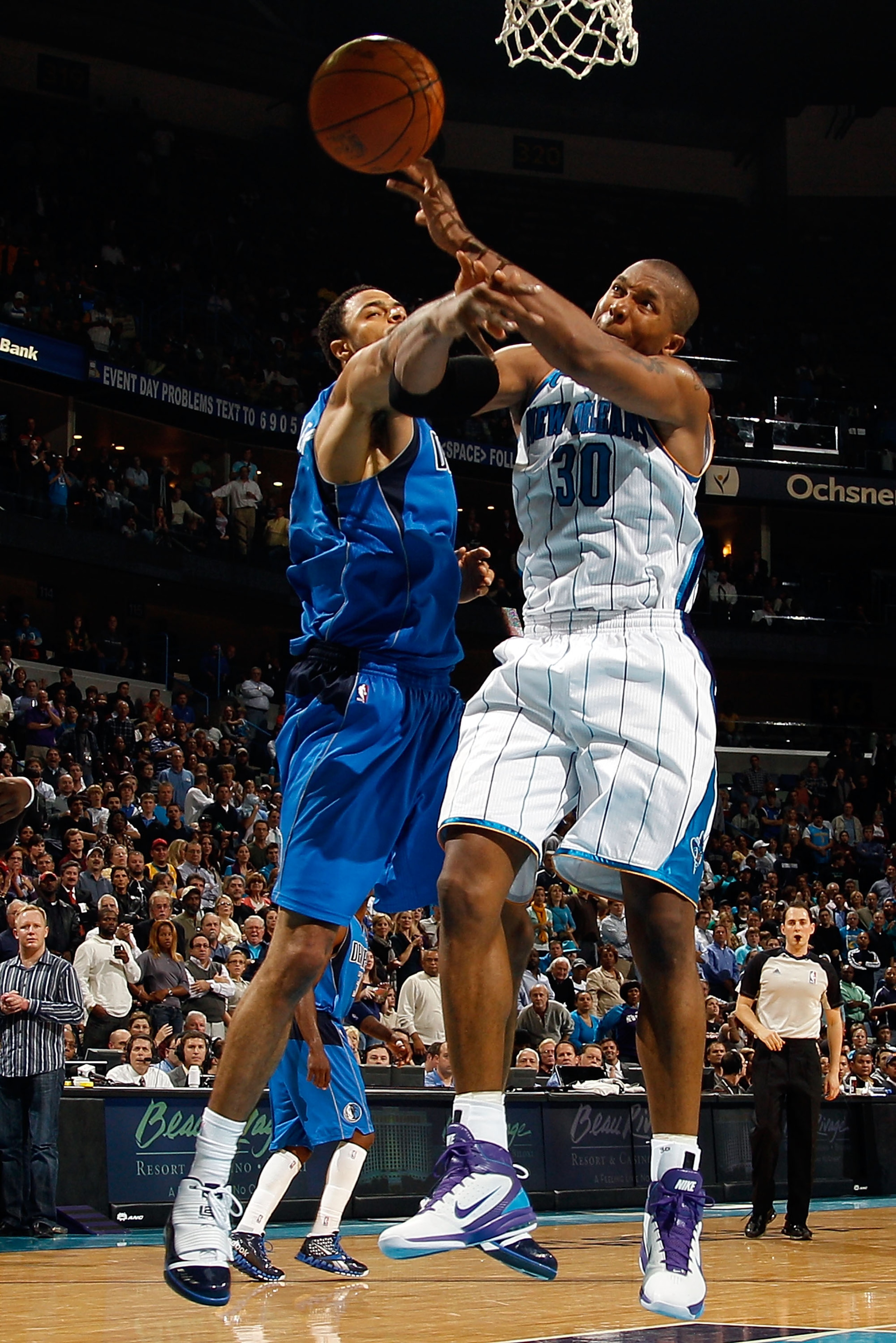 NEW ORLEANS - NOVEMBER 17:  David West #30 of the New Orleans Hornets fights for a rebound with Tyson Chandler #6 of the Dallas Mavericks at the New Orleans Arena on November 17, 2010 in New Orleans, Louisiana.  The Hornets defeated the Mavericks 99-97.