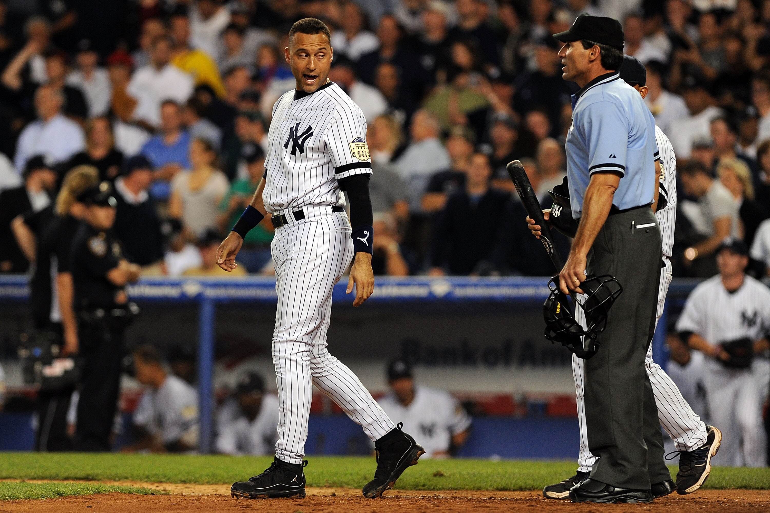 NEW YORK - SEPTEMBER 21:  Derek Jeter #2 of the New York Yankees argues with home plate umpire Angel Hernandez #55 after striking out with bases loaded against the Baltimore Orioles  during the last regular season game at Yankee Stadium on September 21, 2