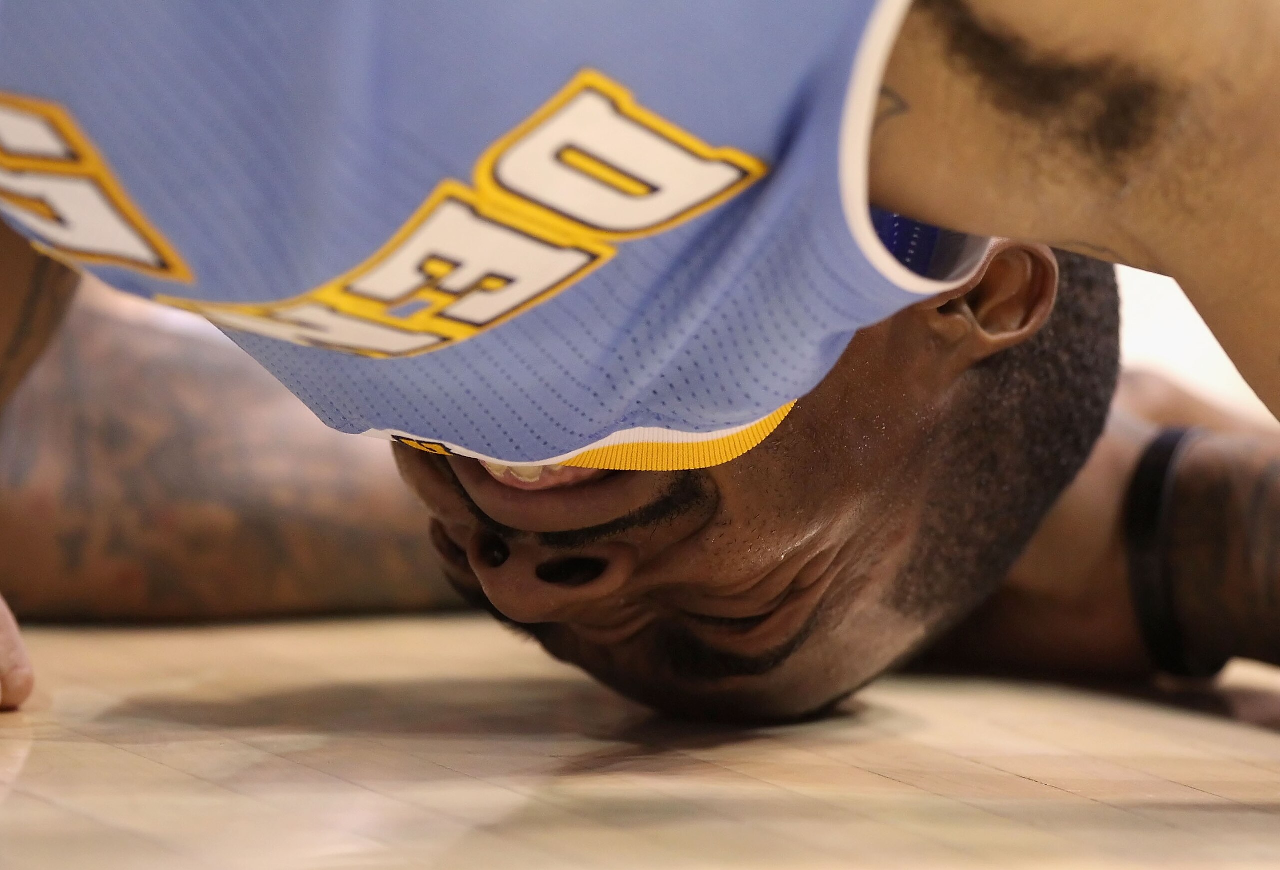 PHOENIX - OCTOBER 22:  J.R. Smith #5 of the Denver Nuggets lays on the court after being injured during the preseason NBA game against the Phoenix Suns at US Airways Center on October 22, 2010 in Phoenix, Arizona. J.R. Smith did return to the game. NOTE T