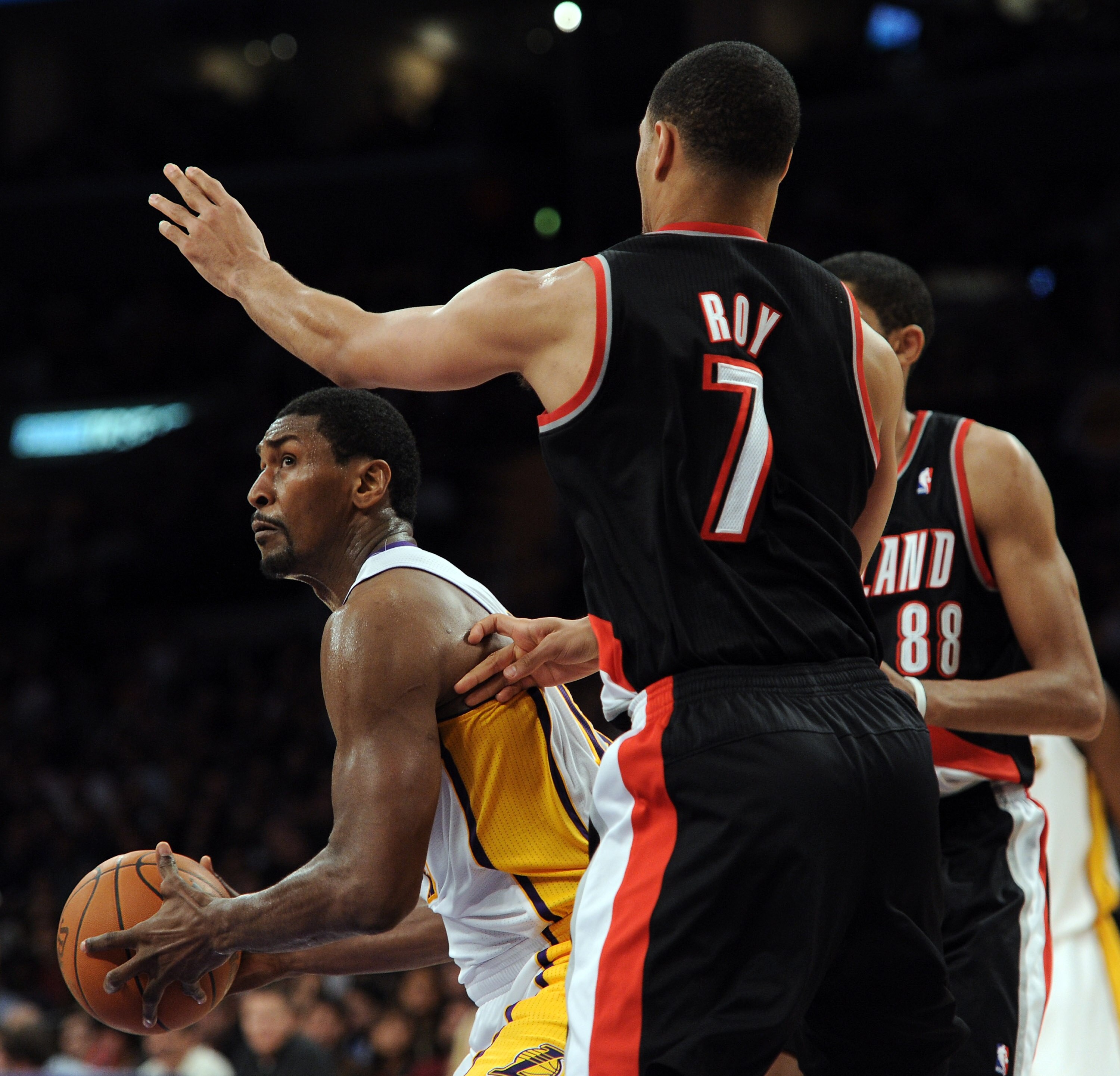 LOS ANGELES, CA - NOVEMBER 07:  Ron Artest #15 of the Los Angeles Lakers looks to pass in front of Brandon Roy #7 of the Portland Trail Blazers at the Staples Center on November 7, 2010 in Los Angeles, California.  NOTE TO USER: User expressly acknowledge