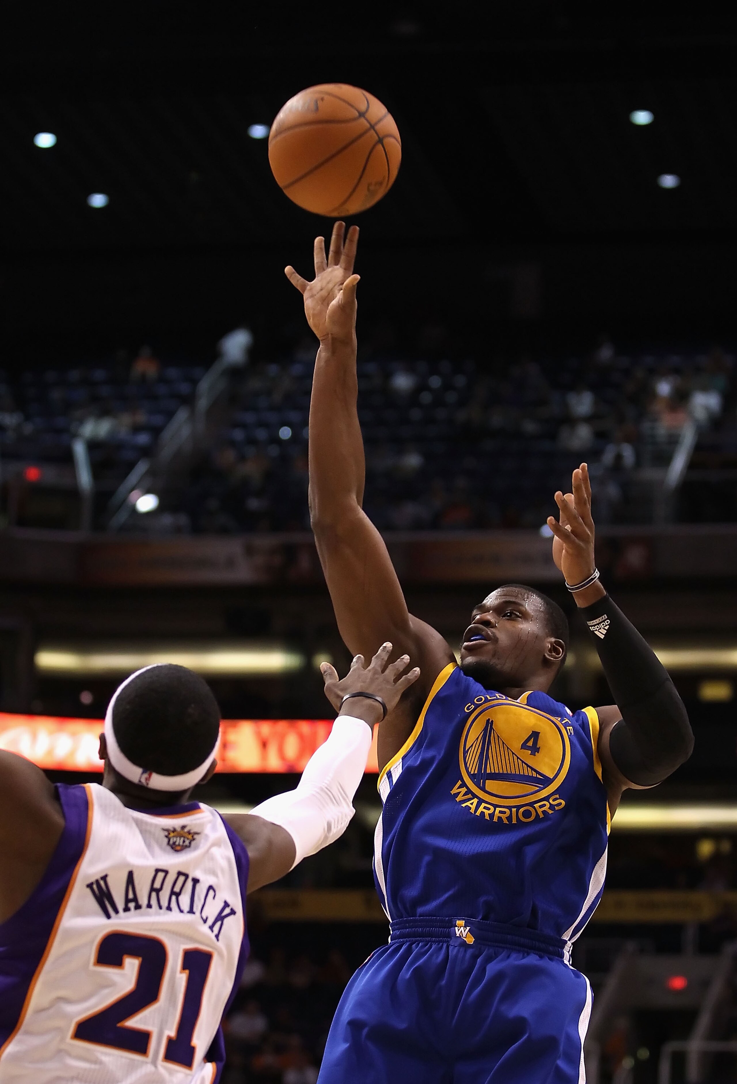 PHOENIX - OCTOBER 19: Jeff Adrien #4 of the Golden State Warriors puts up a shot over Hakim Warrick #21 of the Phoenix Suns during the preseason NBA game at US Airways Center on October 19, 2010 in Phoenix, Arizona. NOTE TO USER: User expressly acknowled PHOENIX - OCTOBER 19: Jeff Adrien #4 of the Golden State Warriors puts up a shot over Hakim Warrick #21 of the Phoenix Suns during the preseason NBA game at US Airways Center on October 19, 2010 in Phoenix, Arizona. NOTE TO USER: User expressly acknowled