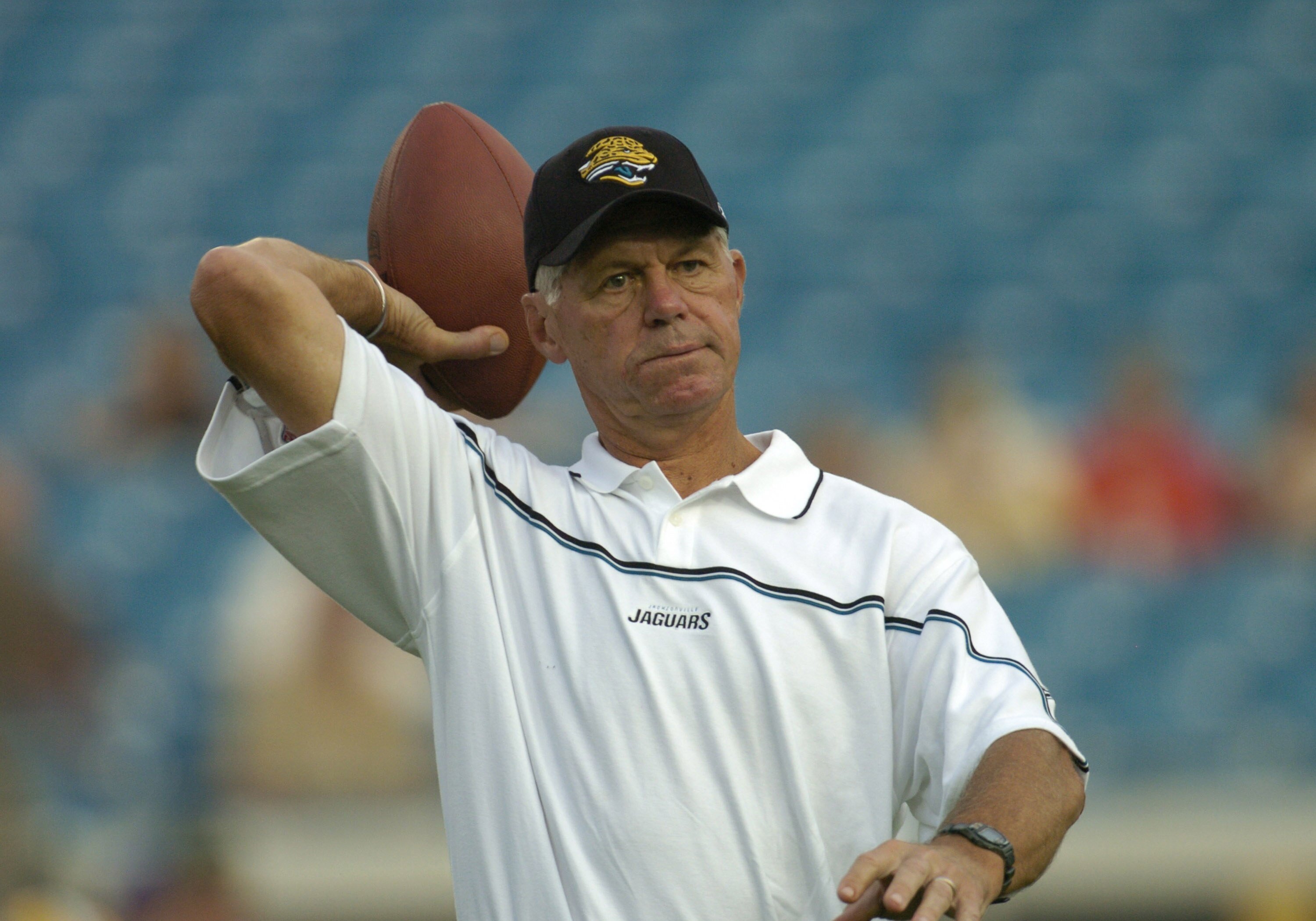 Jacksonville Jaguars wide receivers coach Ken Anderson, a former Cincinnatti Bengals quarterback,  tosses a pass  before  an August 27, 2004 NFL pre-season game  in Jacksonville, Florida.  (Photo by Al Messerschmidt/Getty Images)