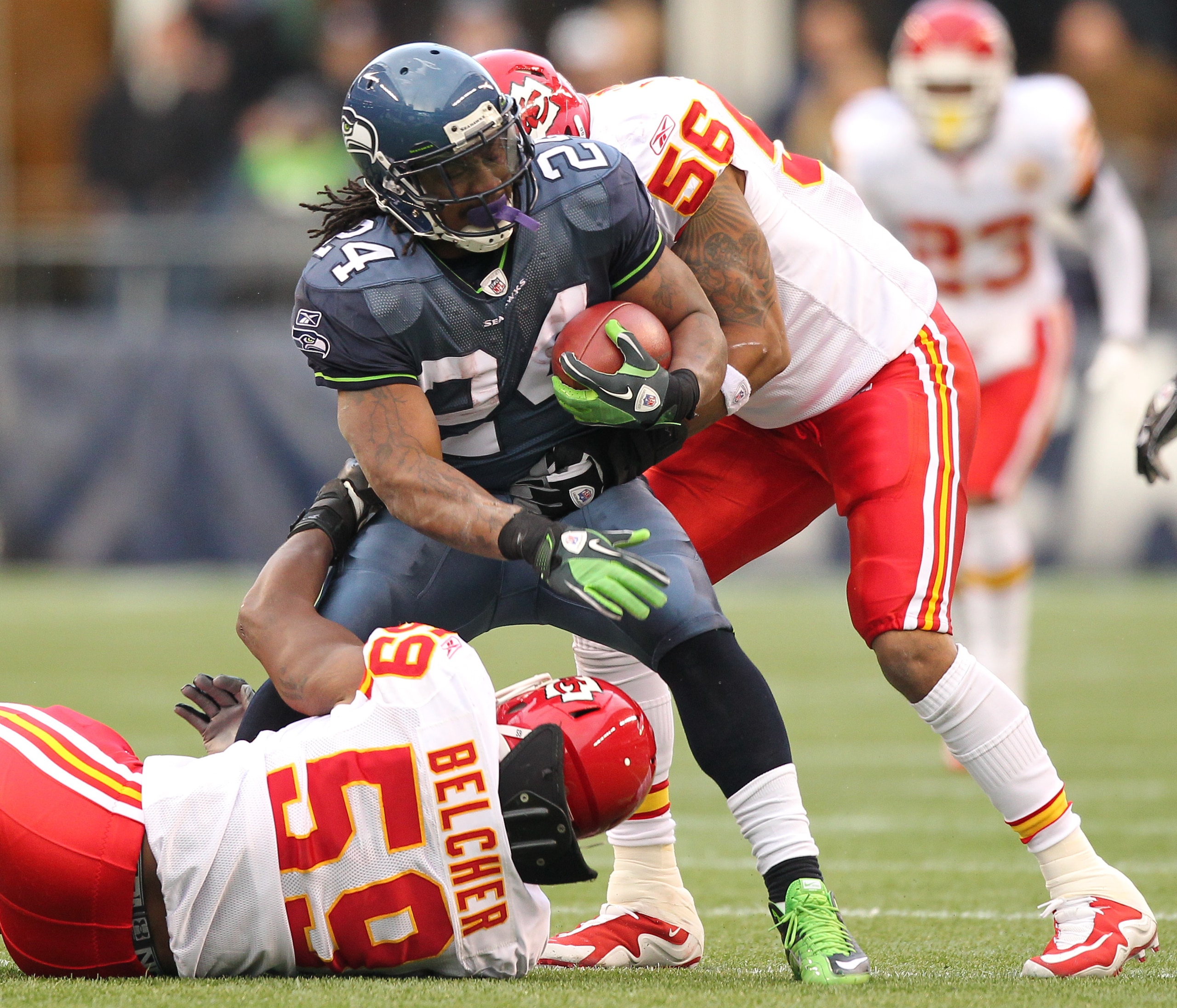 SEATTLE, WA - NOVEMBER 28: Running back Marshawn Lynch #24 of the Seattle Seahawks is wrapped up by Derrick Johnson #56 and Jovan Belcher #59 of the Kansas City Chiefs at Qwest Field on November 28, 2010 in Seattle, Washington. (Photo by Otto Greule Jr/G SEATTLE, WA - NOVEMBER 28: Running back Marshawn Lynch #24 of the Seattle Seahawks is wrapped up by Derrick Johnson #56 and Jovan Belcher #59 of the Kansas City Chiefs at Qwest Field on November 28, 2010 in Seattle, Washington. (Photo by Otto Greule Jr/G