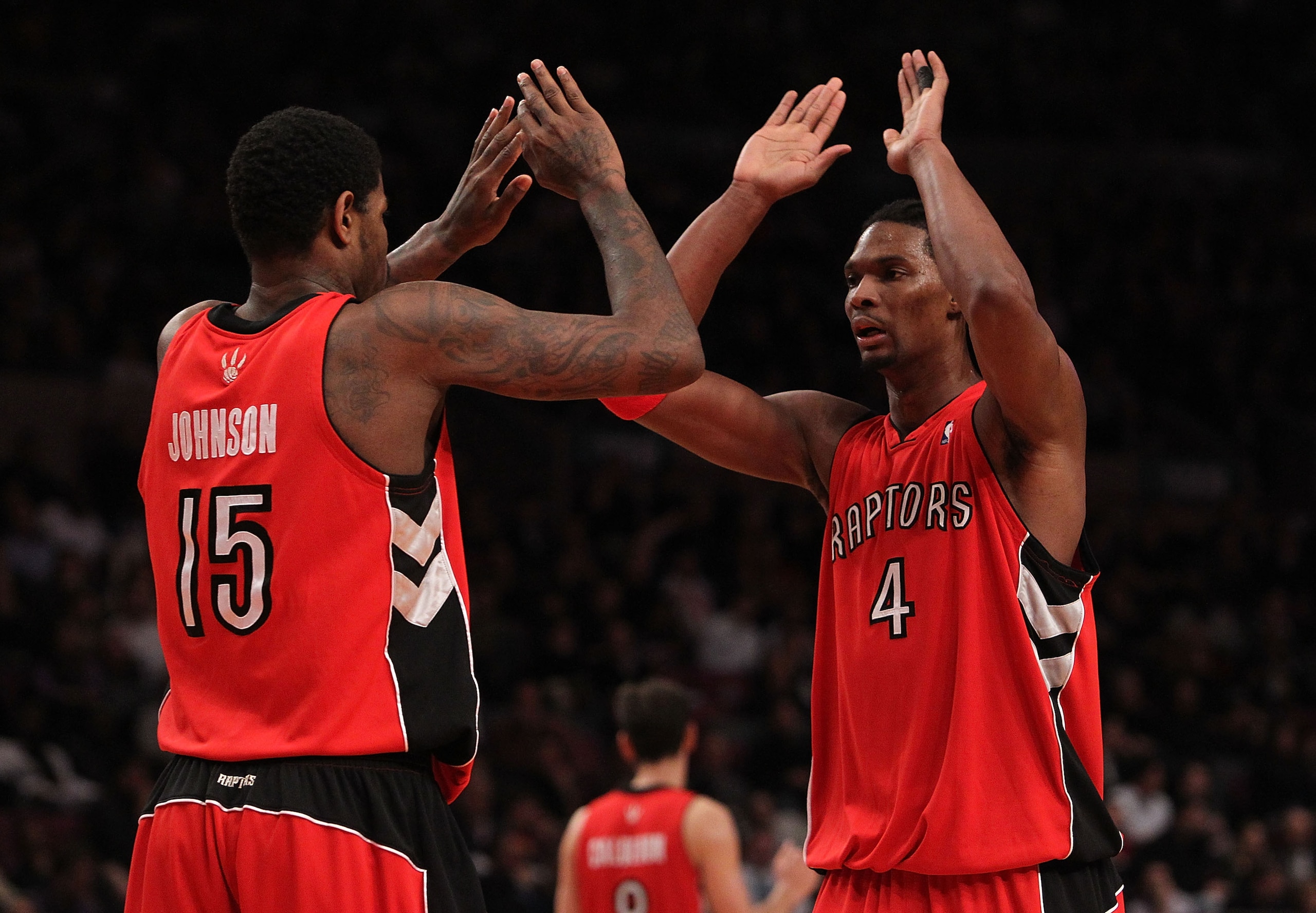 NEW YORK - JANUARY 28:  Chris Bosh #4 of the Toronto Raptors celebrates a basket with teammate Amir Johnson #15 against the New York Knicks at Madison Square Garden on January 28, 2010 in New York, New York. NOTE TO USER: User expressly acknowledges and a