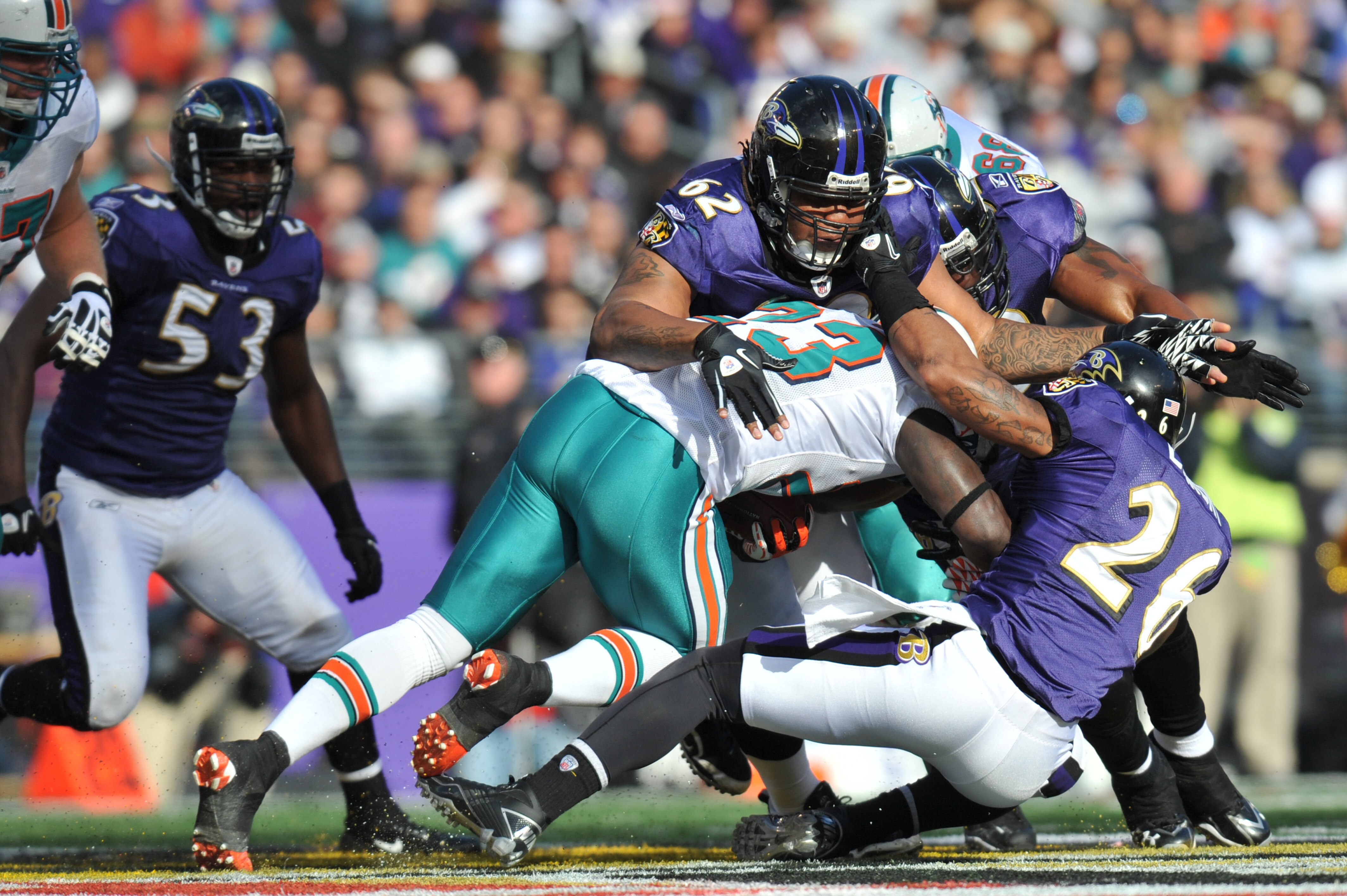 BALTIMORE, MD - NOVEMBER 7:  Terrence Cody #62 of the Baltimore Ravens tackles Ronnie Brown #23 of the Miami Dolphins at M&T Bank Stadium on November 7, 2010 in Baltimore, Maryland. The Ravens defeated the Dolphins 26-10. (Photo by Larry French/Getty Imag