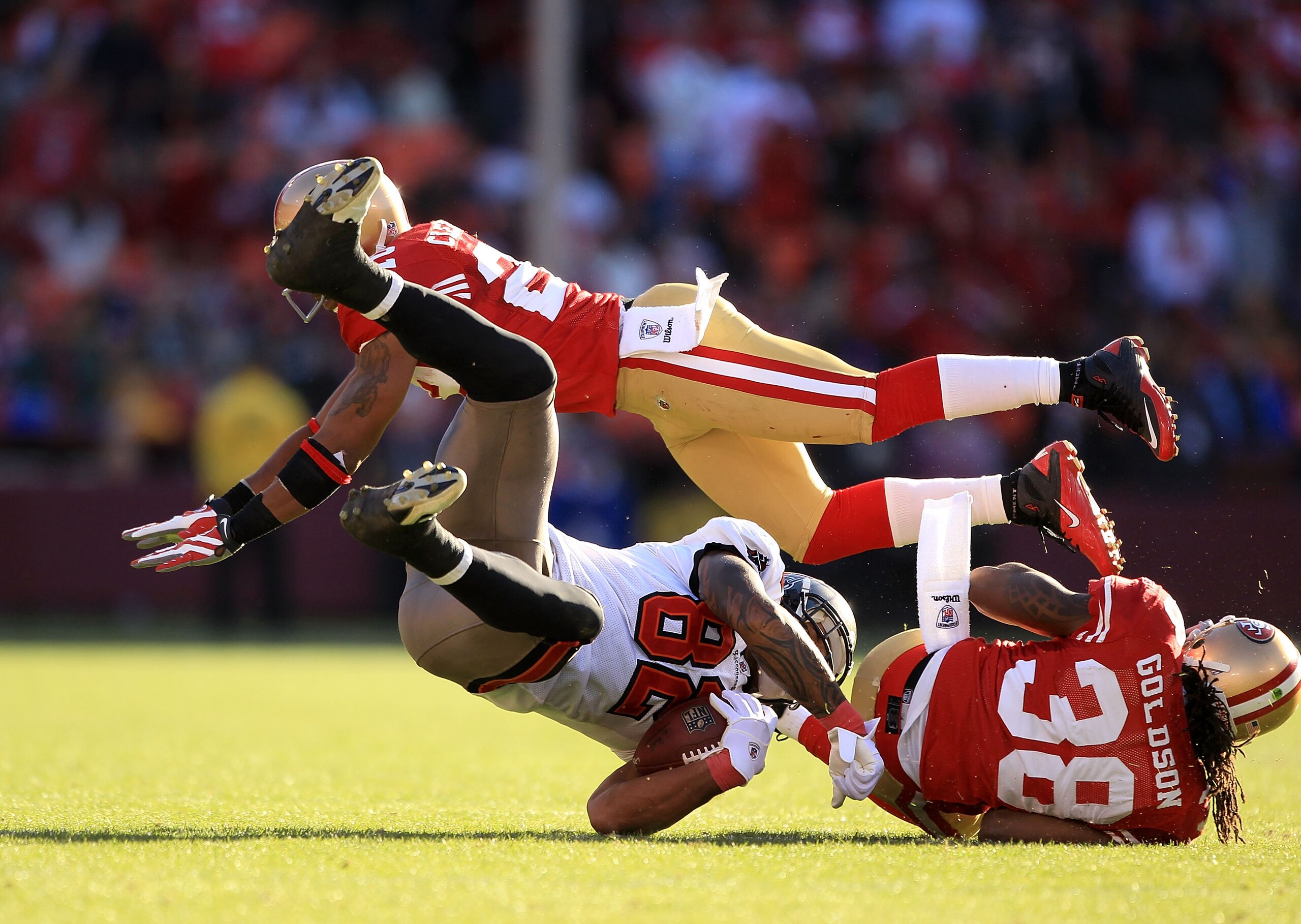 SAN FRANCISCO - NOVEMBER 21: Kellen Winslow #82 of the Tampa Bay Buccaneers is hit by Dashon Goldson #38 and Nate Clements #22 of the San Francisco 49ers at Candlestick Park on November 21, 2010 in San Francisco, California.  (Photo by Ezra Shaw/Getty Ima