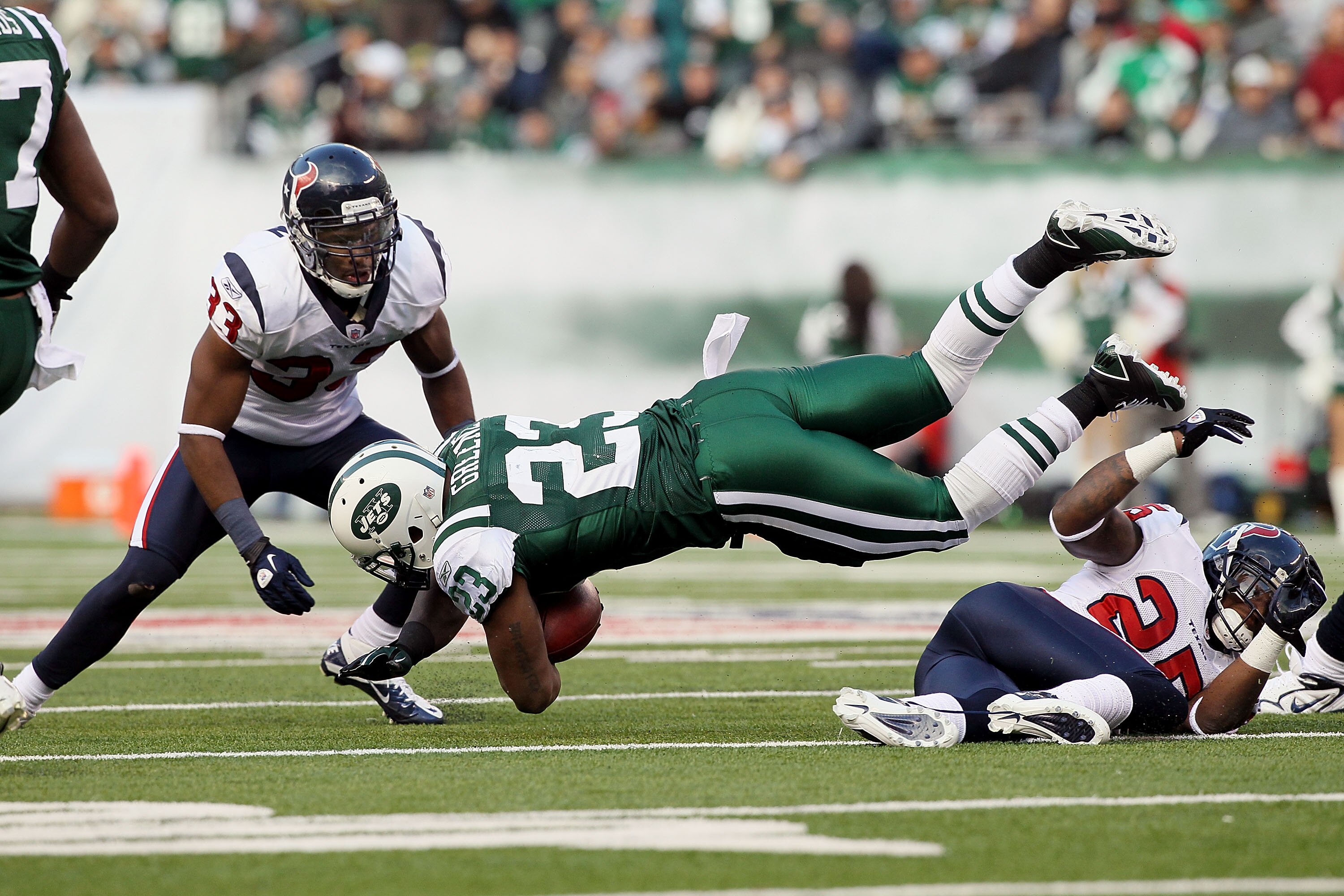 EAST RUTHERFORD, NJ - NOVEMBER 21: Shonn Greene #23 of the New York Jets is upended on a run from Kareem Jackson #25 of the Houston Texans on November 21, 2010 at the New Meadowlands Stadium in East Rutherford, New Jersey.  (Photo by Jim McIsaac/Getty Ima