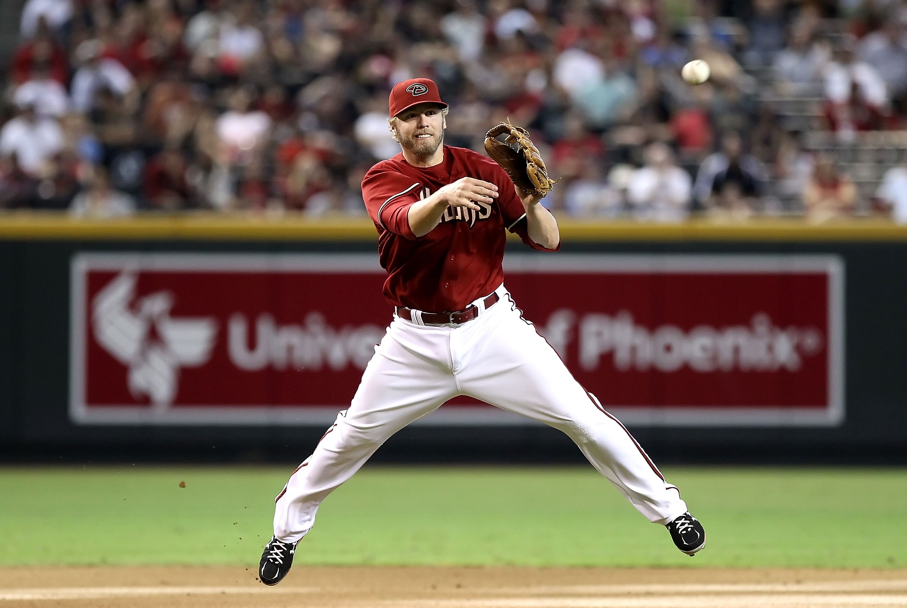 PHOENIX - SEPTEMBER 06:  Infielder Mark Reynolds #27 of the Arizona Diamondbacks fields a ground ball out during the Major League Baseball game against  the San Francisco Giants at Chase Field on September 6, 2010 in Phoenix, Arizona. The Giants defeated