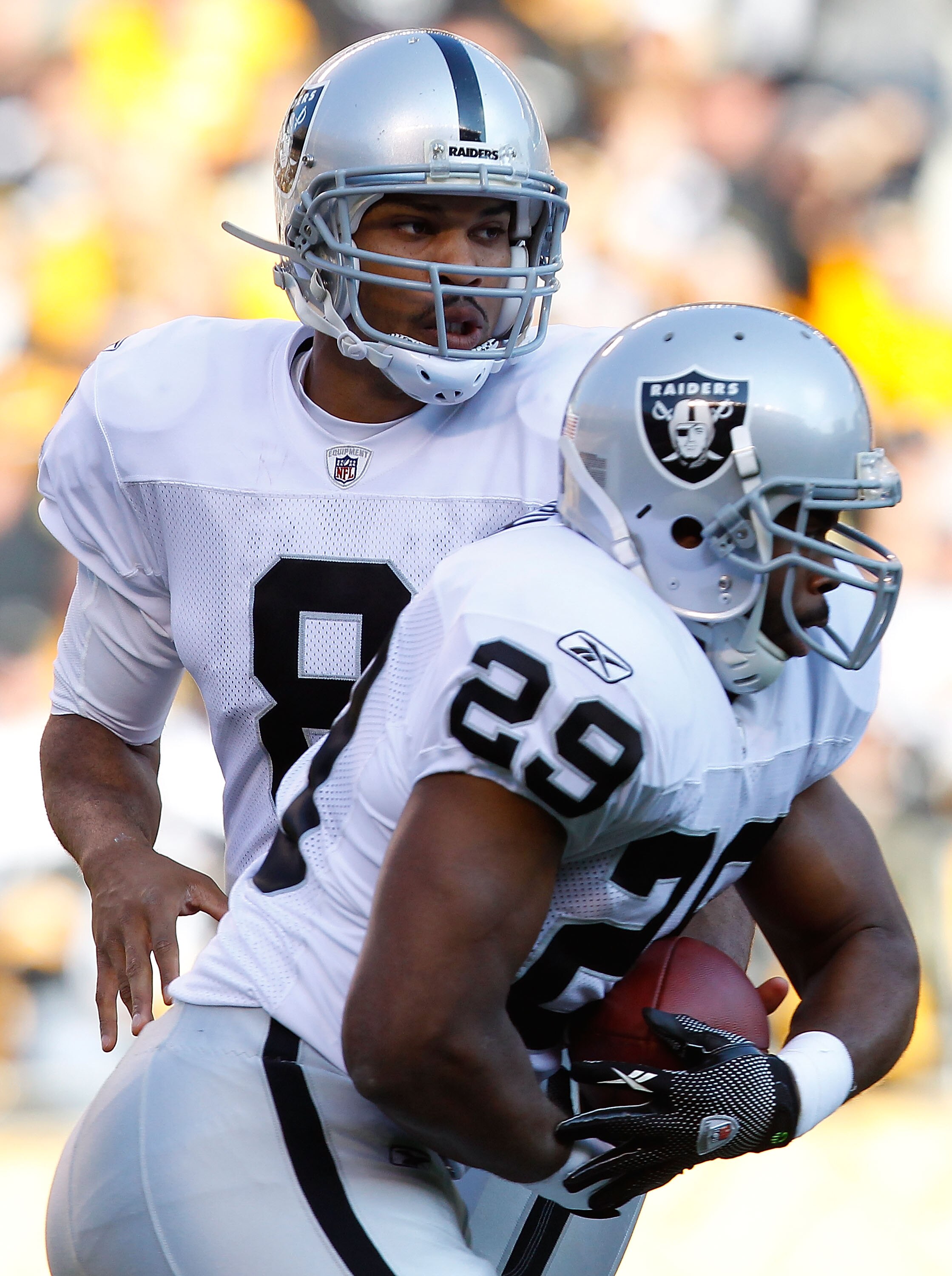 PITTSBURGH, PA - NOVEMBER 21:  Jason Campbell #8 of the Oakland Raiders hands the ball off to teammate Michael Bush #29 during the game against the Pittsburgh Steelers on November 21, 2010 at Heinz Field in Pittsburgh, Pennsylvania.  (Photo by Jared Wicke
