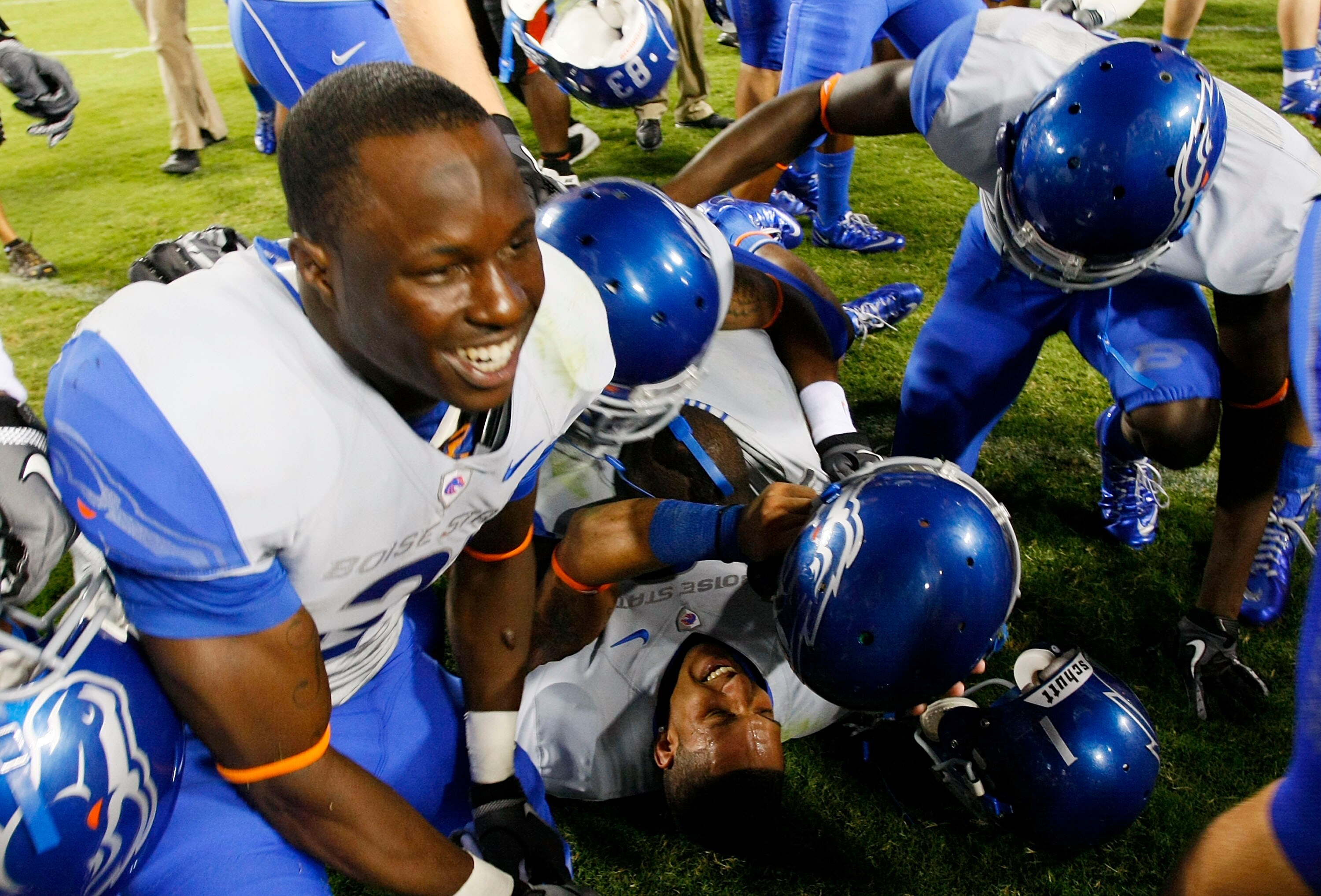 LANDOVER, MD - SEPTEMBER 06:  Wide reciever Austin Pettis (bottom) of the Boise State Broncos is mobbed by teammates after the Broncos defeated the Virginia Tech Hokies 33-30  at FedExField on September 6, 2010 in Landover, Maryland.  (Photo by Geoff Burk