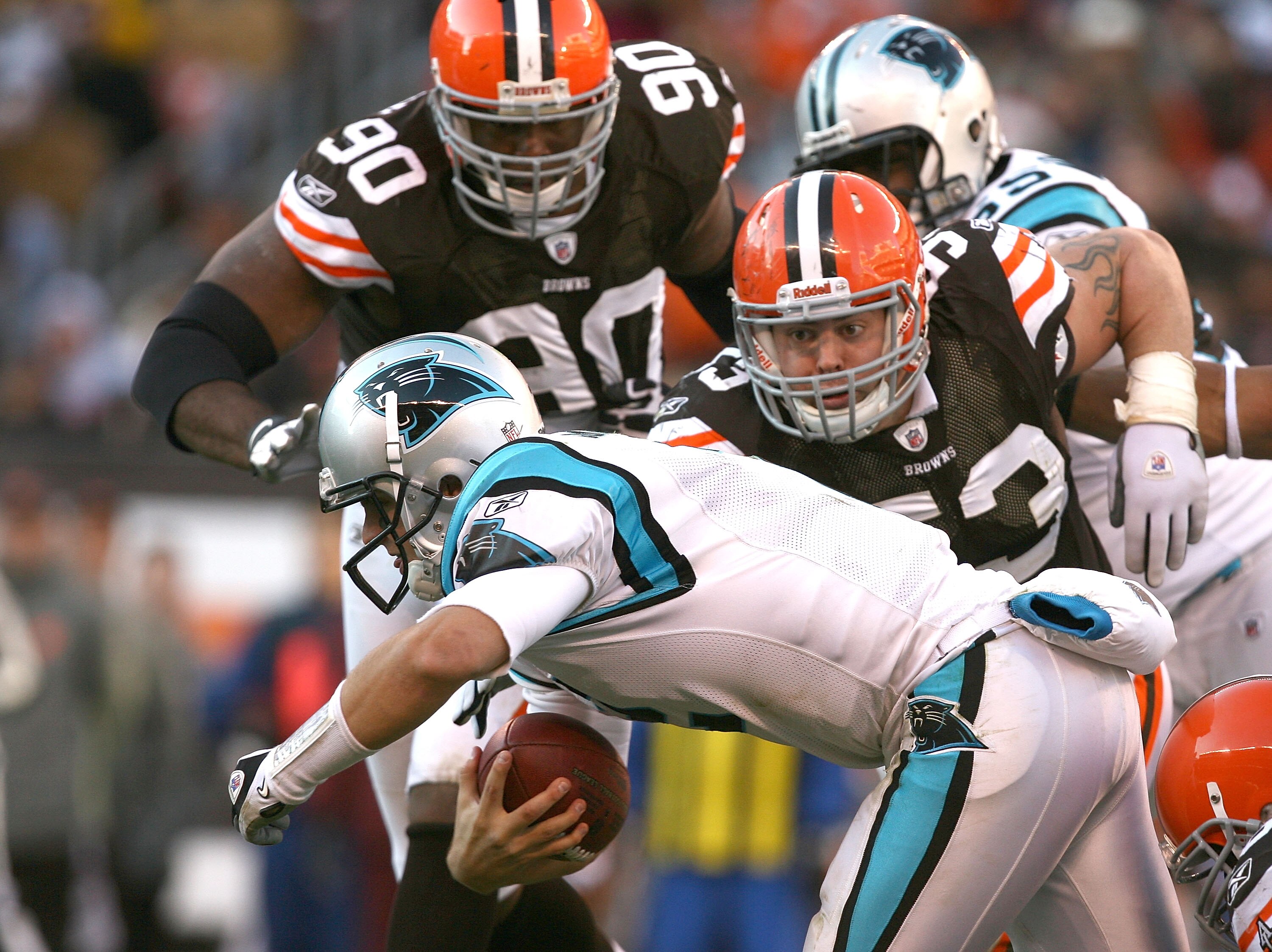 CLEVELAND - NOVEMBER 28:  Quarterback Jimmy Clausen #2 of the Carolina Panthers is sacked by defenders Kenyon Coleman #90 and Matt Roth #53 of the Cleveland Browns at Cleveland Browns Stadium on November 28, 2010 in Cleveland, Ohio.  (Photo by Matt Sulliv