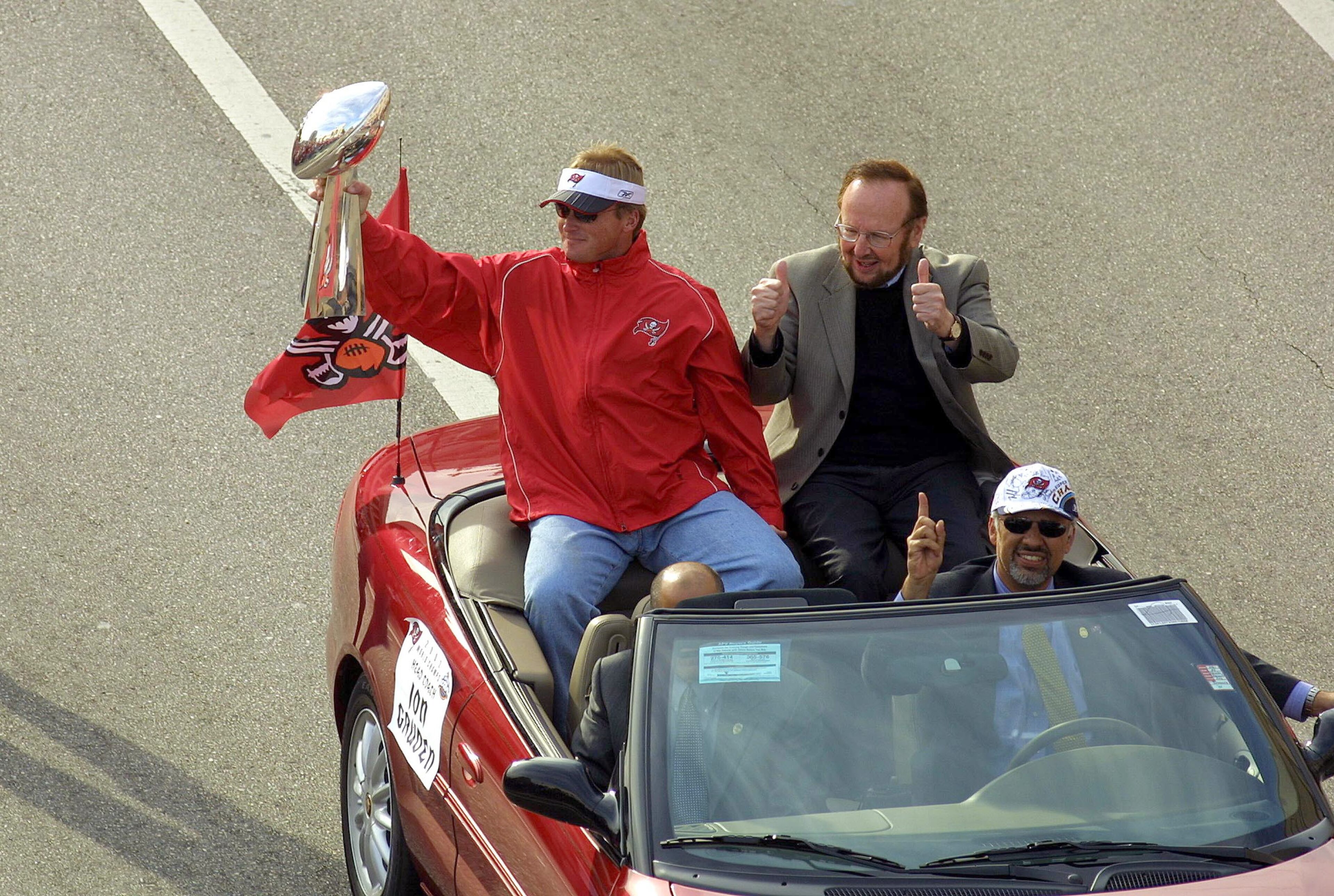 TAMPA, FL - JANUARY 28:  Head Coach Jon Gruden of the Tampa Bay Buccaneers rides with team Owner/President Malcolm Glazer during a victory parade on January 28, 2003 in Tampa, Florida. The Buccaneers defeated the Oakland Raiders 48-21 in Super Bowl XXXVII