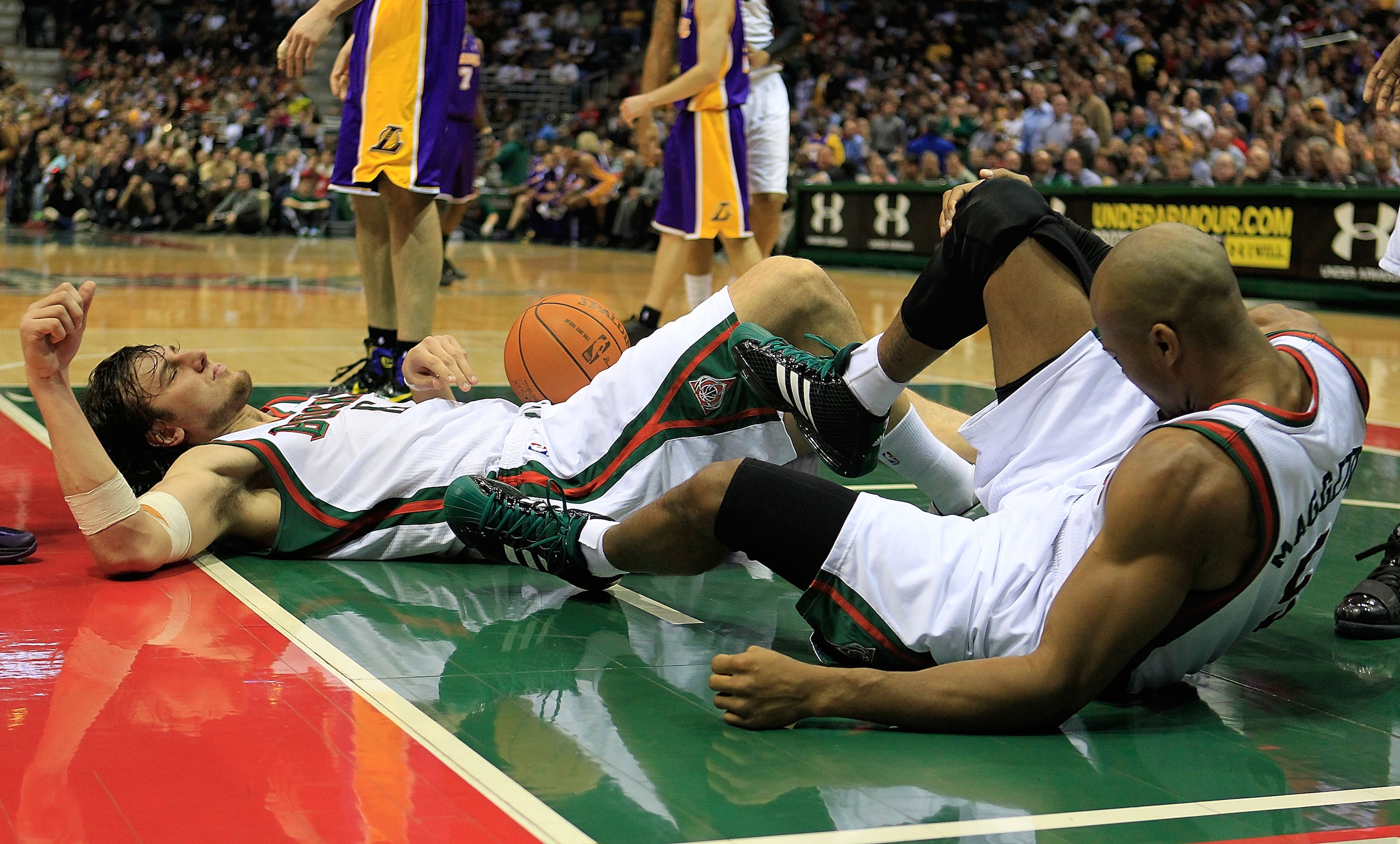 MILWAUKEE - NOVEMBER 16: Andrew Bogut #6 (L) and Corey Maggette #5 of the Milwaukee Bucks lay on the floor after colliding during a game against the Los Angeles Lakers at the Bradley Center on November 16, 2010 in Milwaukee, Wisconsin. The Lakers defeated