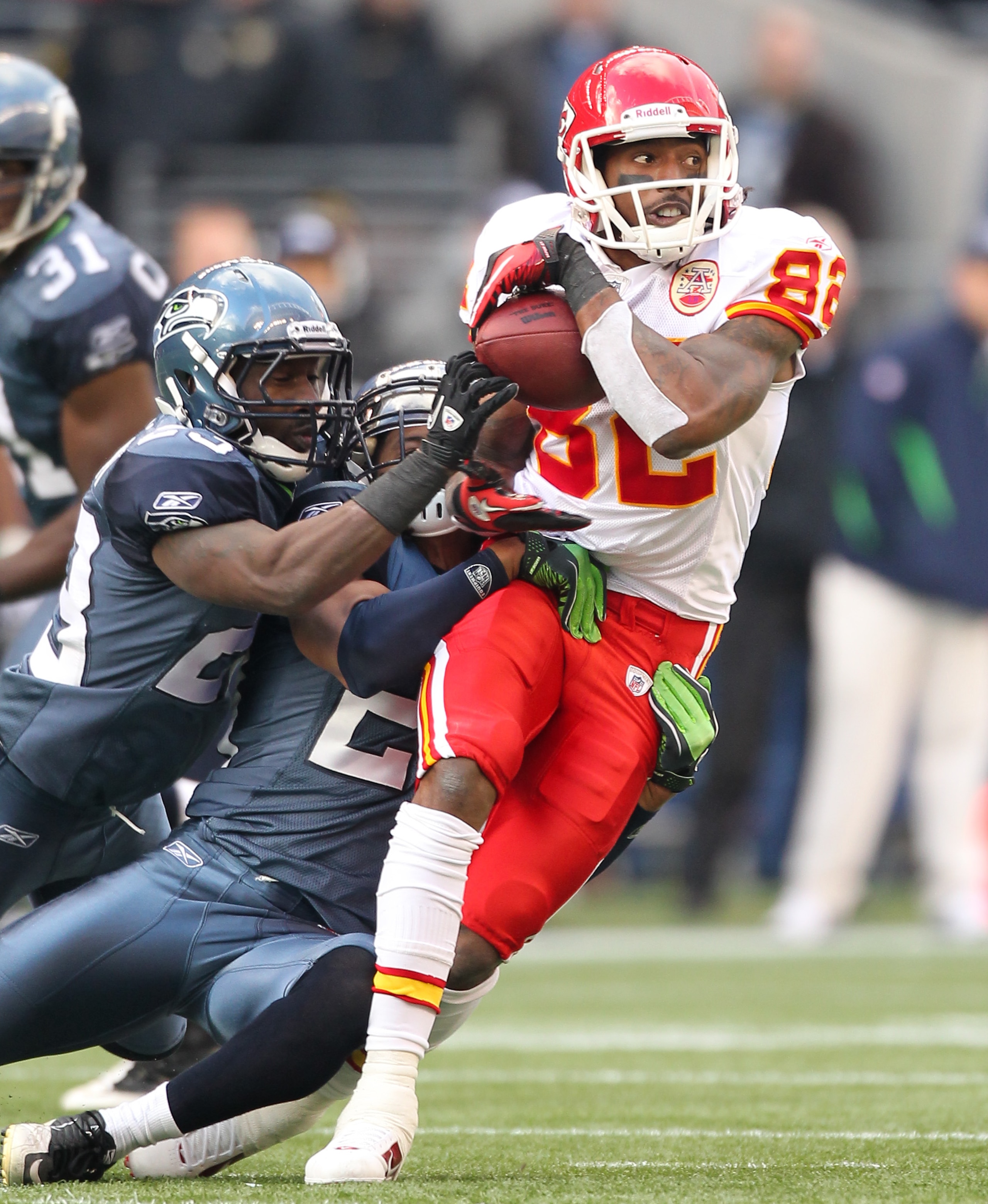 SEATTLE, WA - NOVEMBER 28:  Wide receiver Dwayne Bowe #82 of the Kansas City Chiefs rushes against Earl Thomas #29 and Marcus Trufant #23 of the Seattle Seahawks at Qwest Field on November 28, 2010 in Seattle, Washington. The Chiefs defeated the Seahawks