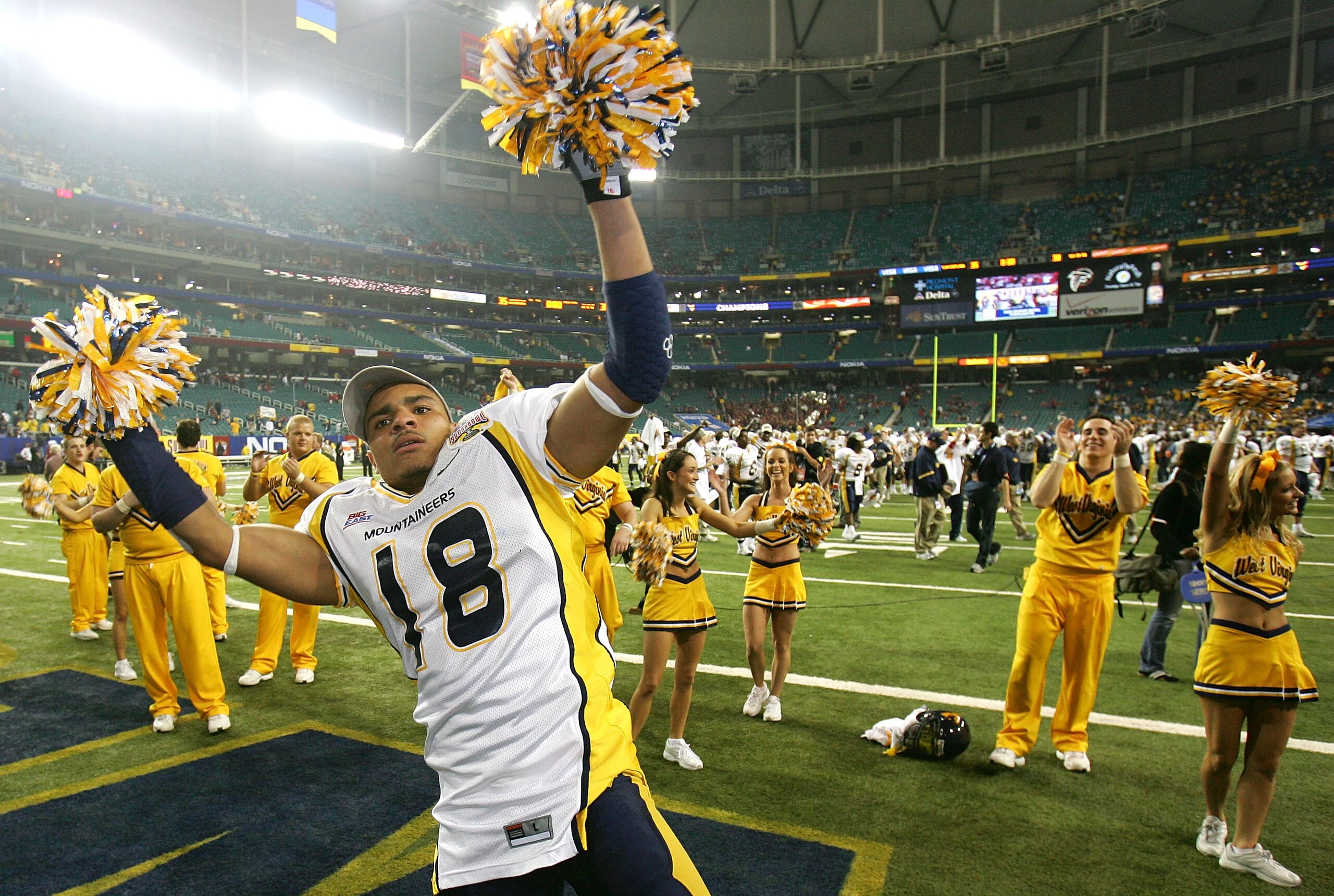 ATLANTA - JANUARY 02:  Abraham Jones #18 of the West Virginia Mountaineers celebrates with cheerleaders after defeating the Georgia Bulldogs 38-35 in the Nokia Sugar Bowl at the Georgia Dome on January 2, 2006 in Atlanta, Georgia.  (Photo by Streeter Leck