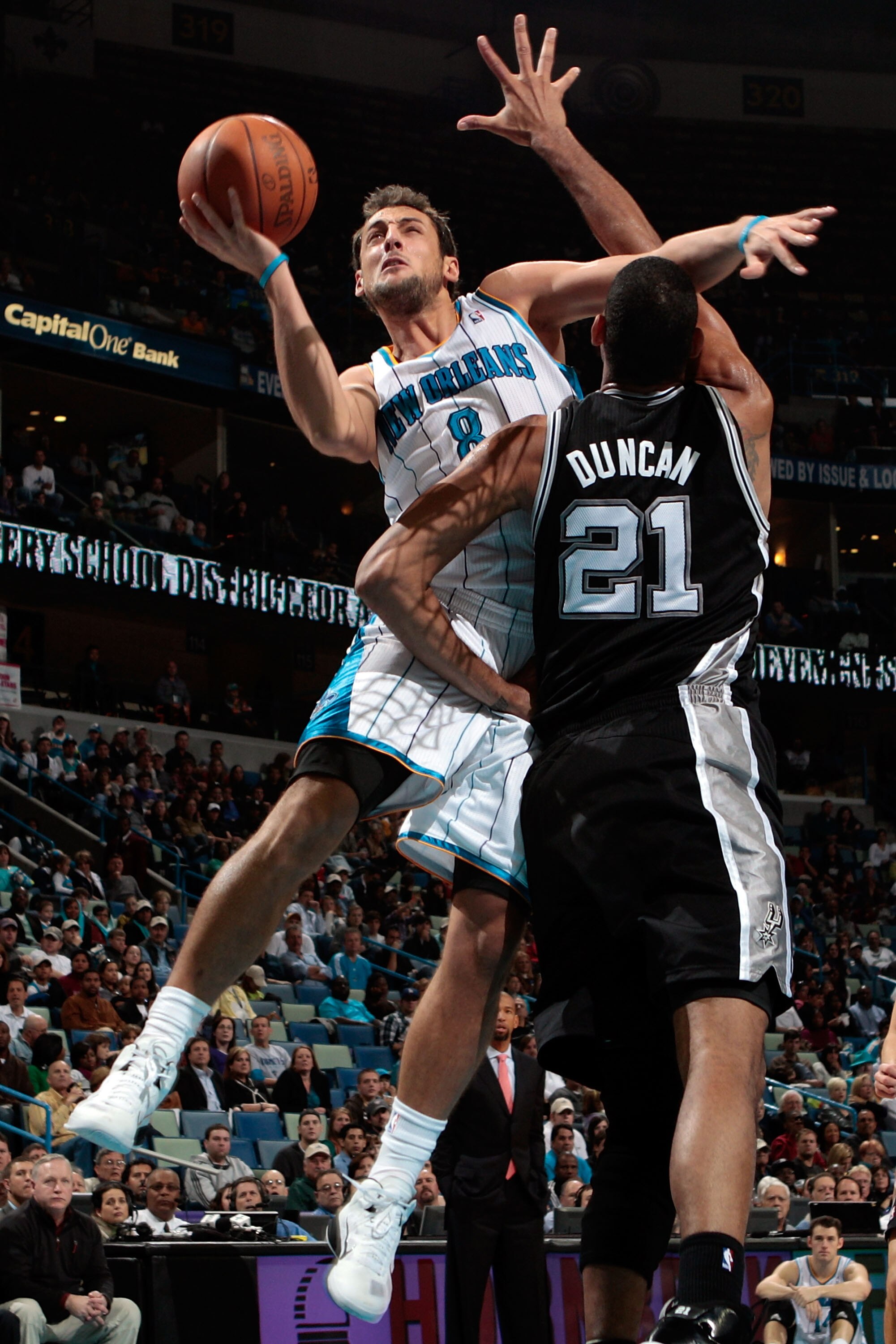 NEW ORLEANS - NOVEMBER 28:  Marco Belinelli #8 of the New Orleans Hornets shoots the ball over Tim Duncan #21 of the San Antonio Spurs at the New Orleans Arena on November 28, 2010 in New Orleans, Louisiana.  NOTE TO USER: User expressly acknowledges and